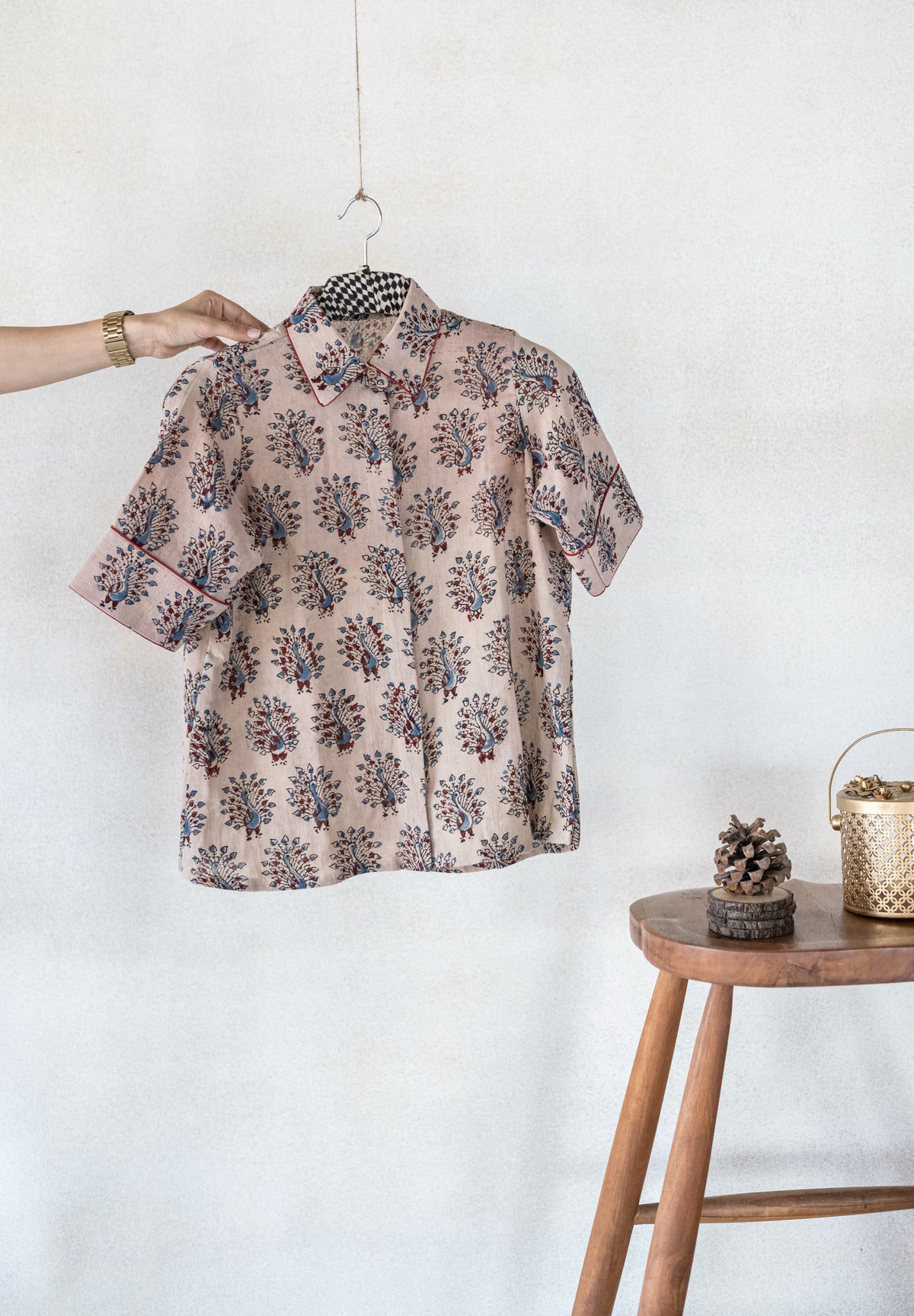 Hand spun and handwoven organic cotton beige Ajrakh hand block printed shirt for women featuring peacock motif and madder dyed piping on collar and cuffs, naturally dyed and crafted for breathable everyday comfort.