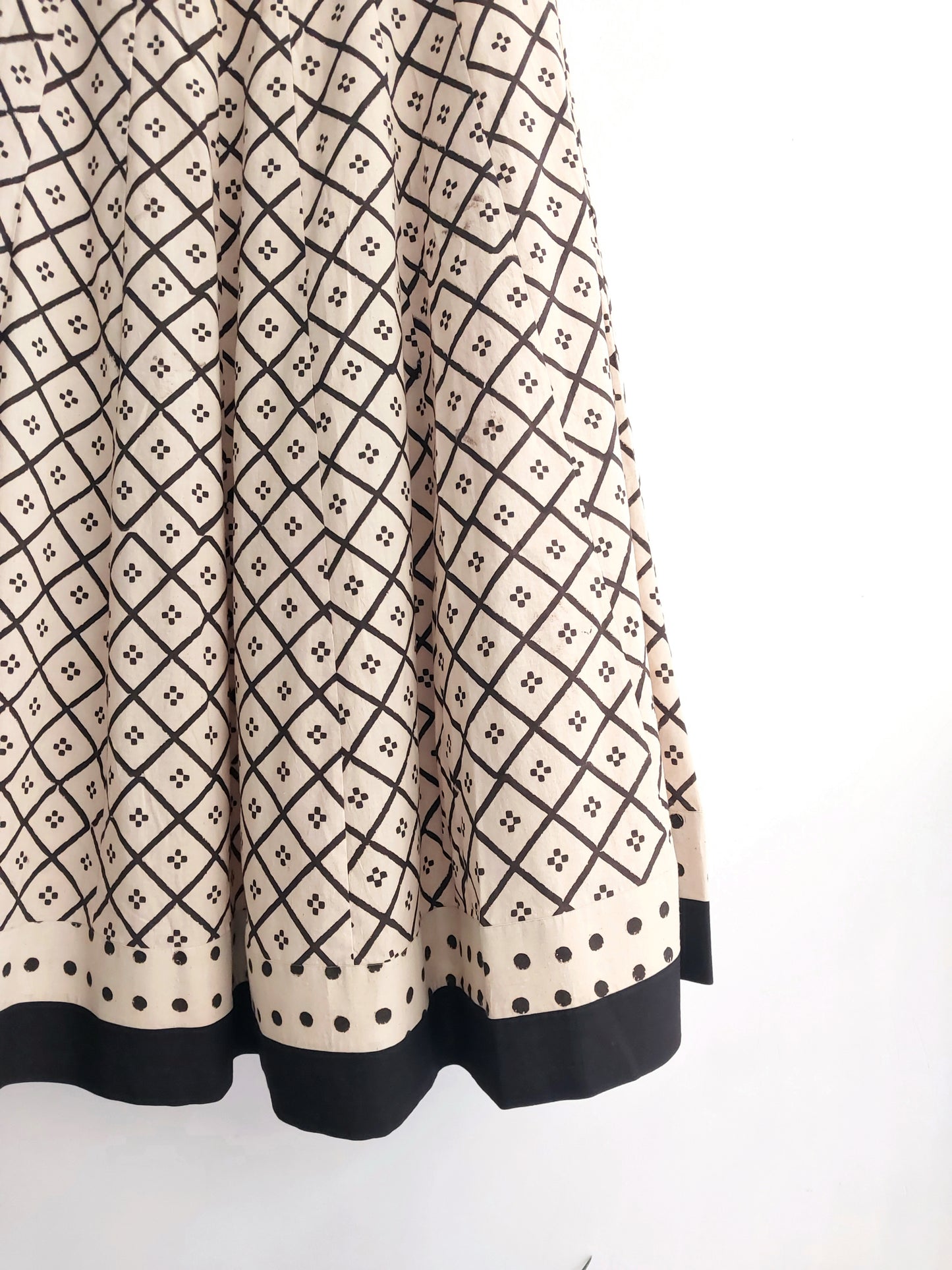 Beige natural dyed Ajrakh hand block printed kali-cut skirt with borders, side zip and drawstring. Handmade slow-made cotton skirt styled with a black Ajrakh blouse.
