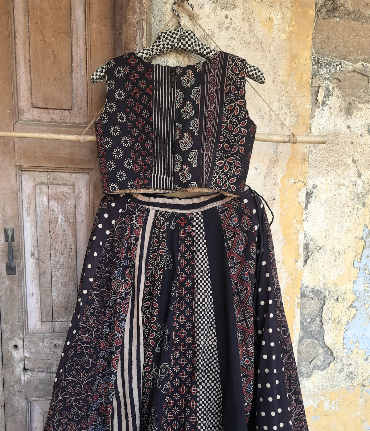 Black natural dyed Ajrakh hand block printed blouse with front button closure, deep curved V-neck, lined and padded cotton fabric