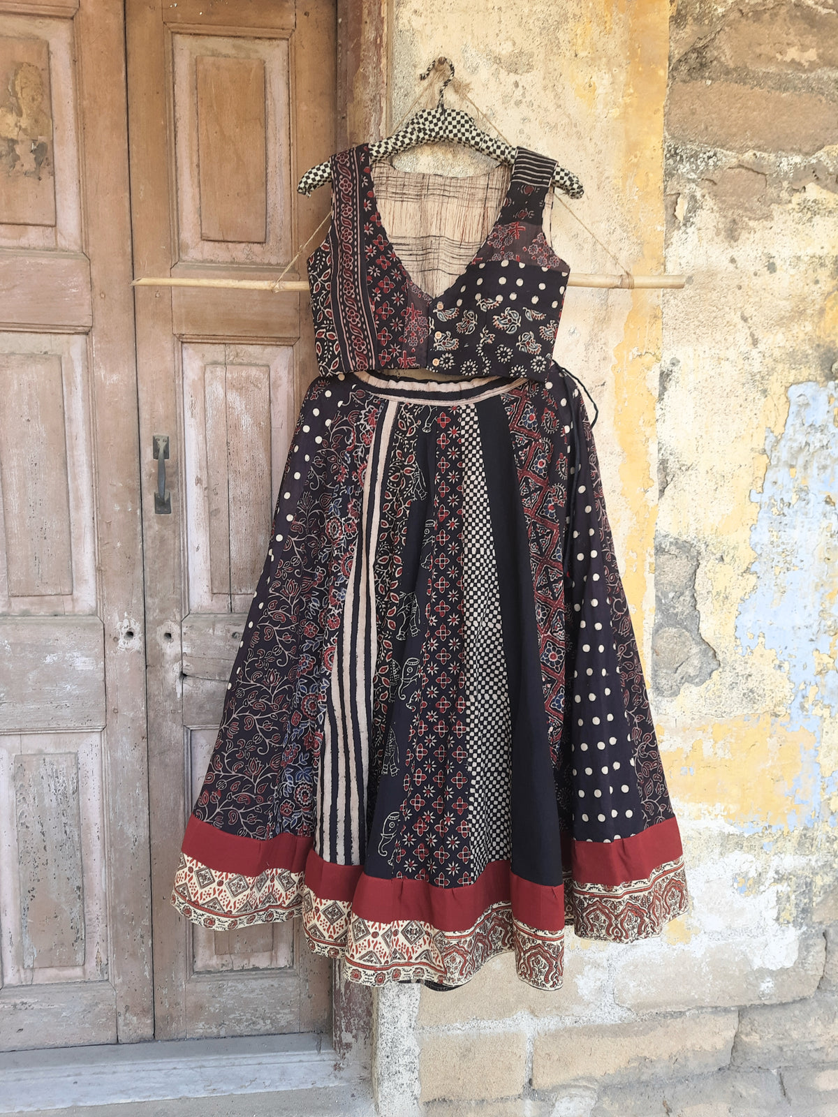 Black natural dyed Ajrakh hand block printed skirt and blouse set with flared kali skirt, multi Ajrakh panels, lined padded blouse and handcrafted details