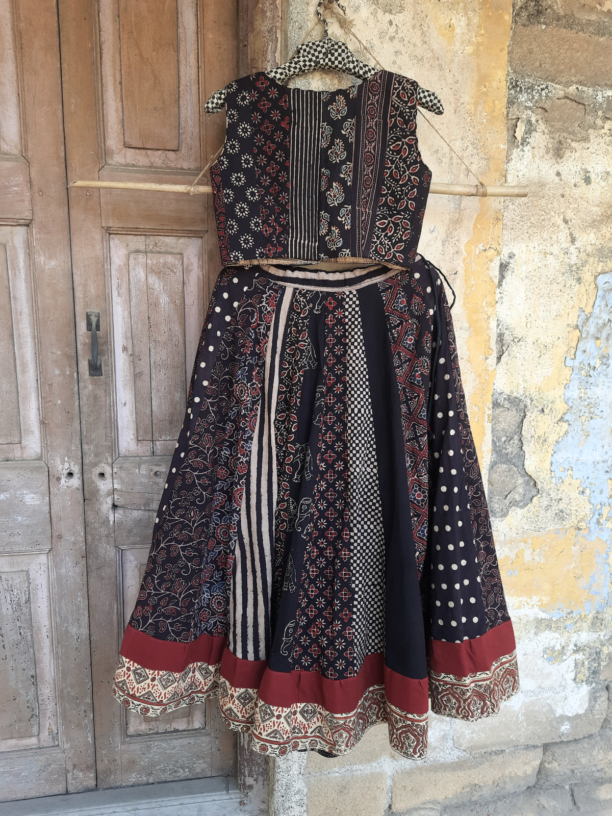 Black natural dyed Ajrakh hand block printed skirt and blouse set with flared kali skirt, multi Ajrakh panels, lined padded blouse and handcrafted details