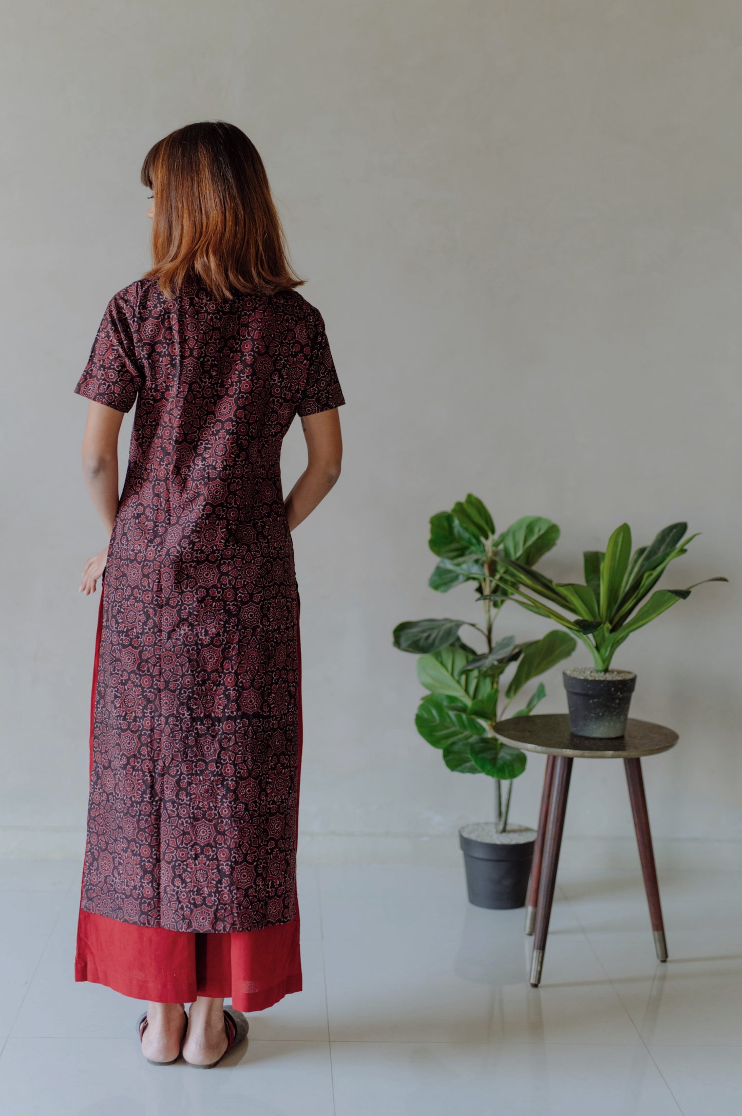 Natural black Ajrakh hand block printed cotton kurta with mandarin collar paired with madder red naturally dyed cotton pants featuring elasticated waist. Handmade, breathable, slow made Indian wear crafted by artisans in Gujarat.