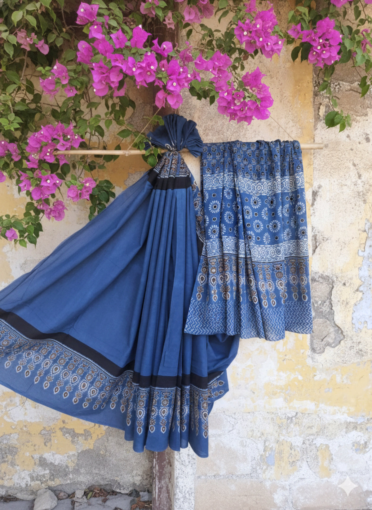 Solid indigo dyed Ajrakh hand block printed cotton saree featuring a calm indigo body with intricately printed Ajrakh borders and pallu. Natural dyed, breathable and slow made saree handcrafted by artisans in Gujarat.