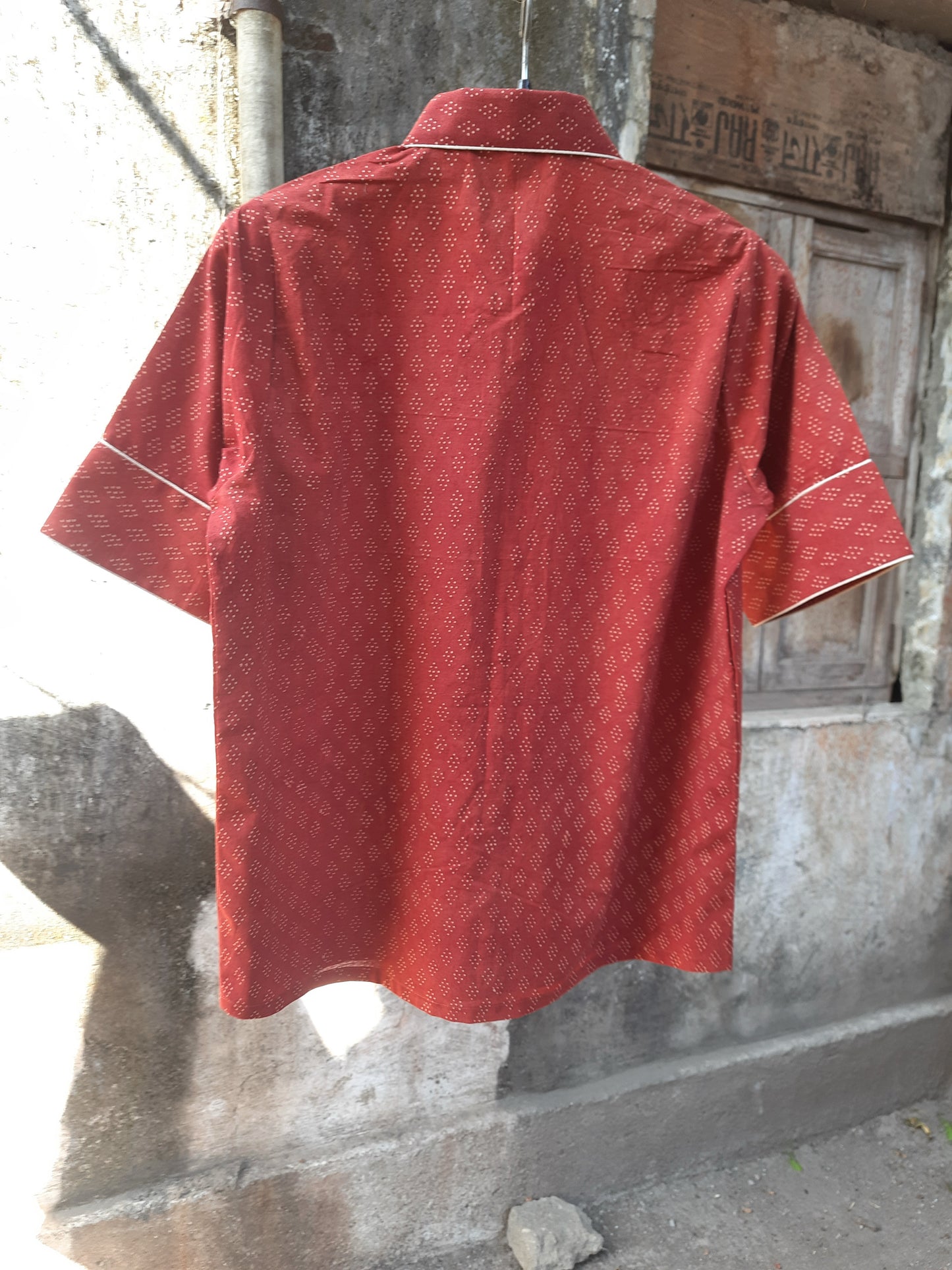 Madder dyed Ajrakh hand block printed cotton shirt for women in deep red tone, crafted in breathable pure cotton with a collared neck and contrast piping, naturally dyed and handmade for everyday comfort.