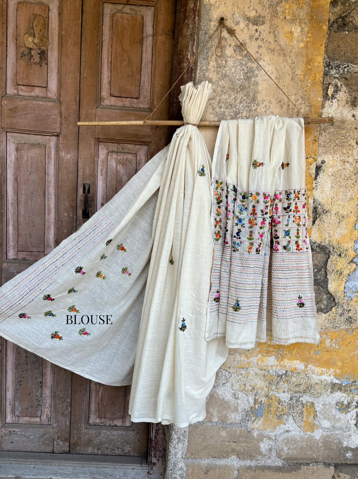 Handspun and handwoven cotton saree in warm ivory shade with expressive hand embroidered floral motifs and subtle sequin detailing. Slow made artisanal saree named Phagun, inspired by spring, with a hand embroidered blouse piece.