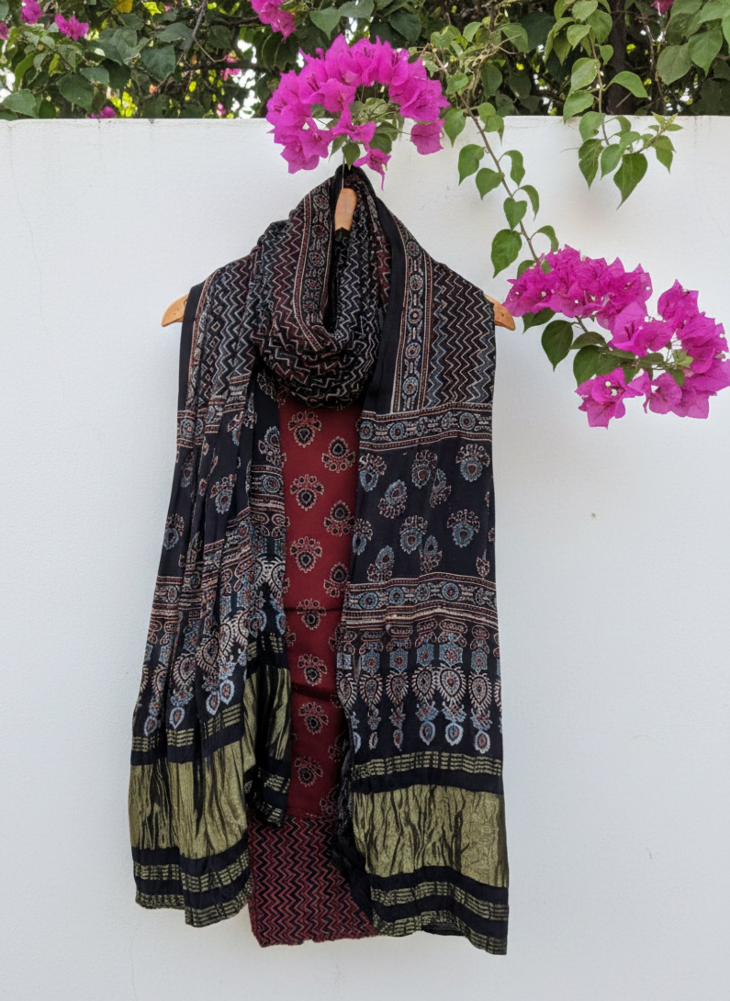 Ajrakh hand block printed unstitched suit set in red and black with traditional motifs and patterned dupatta.