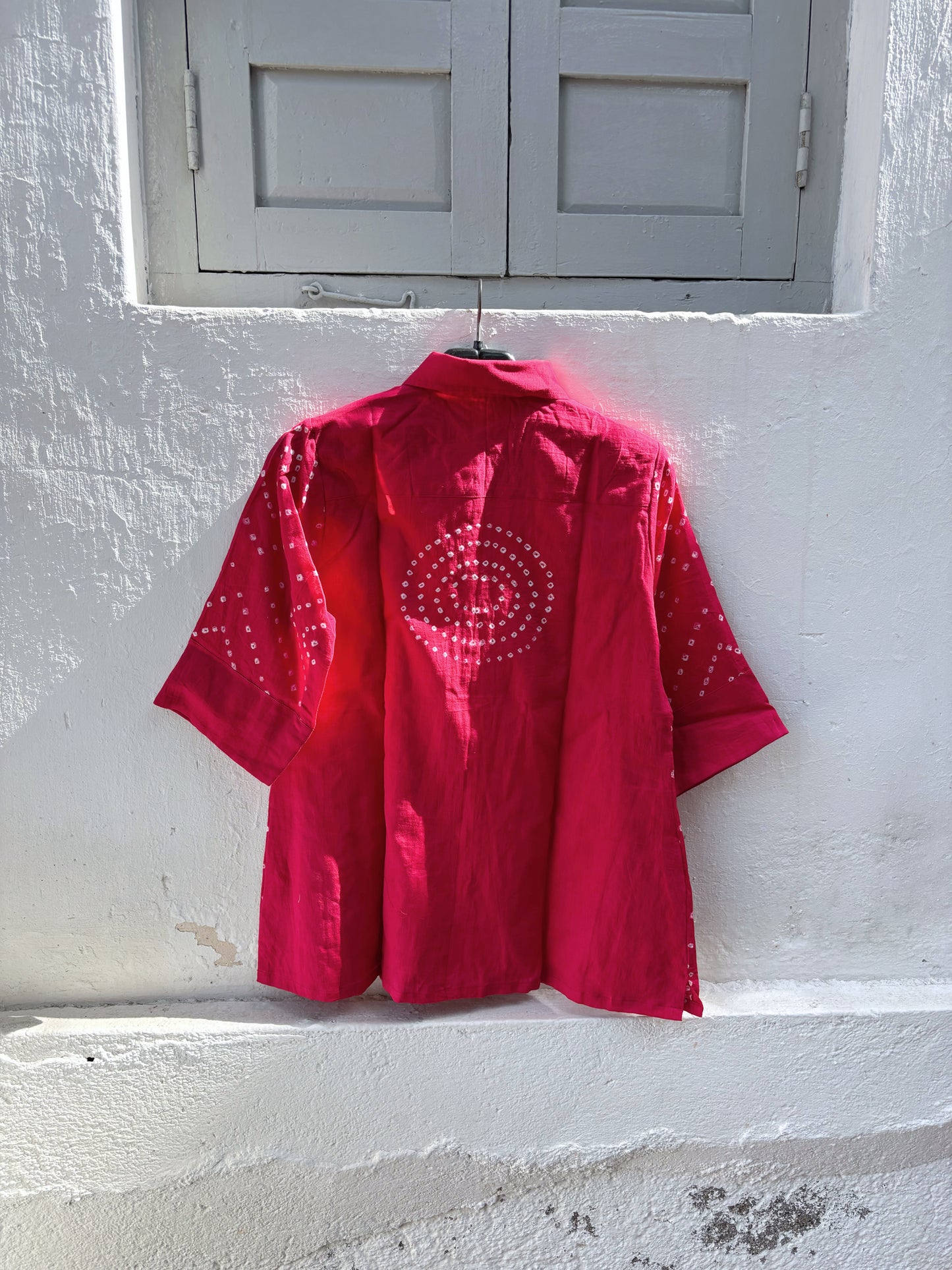 Hand tie-dyed Bougainvillea Pink Bandhani cotton satin shirt with geometric white Bandhani motifs and a classic shirt collar.