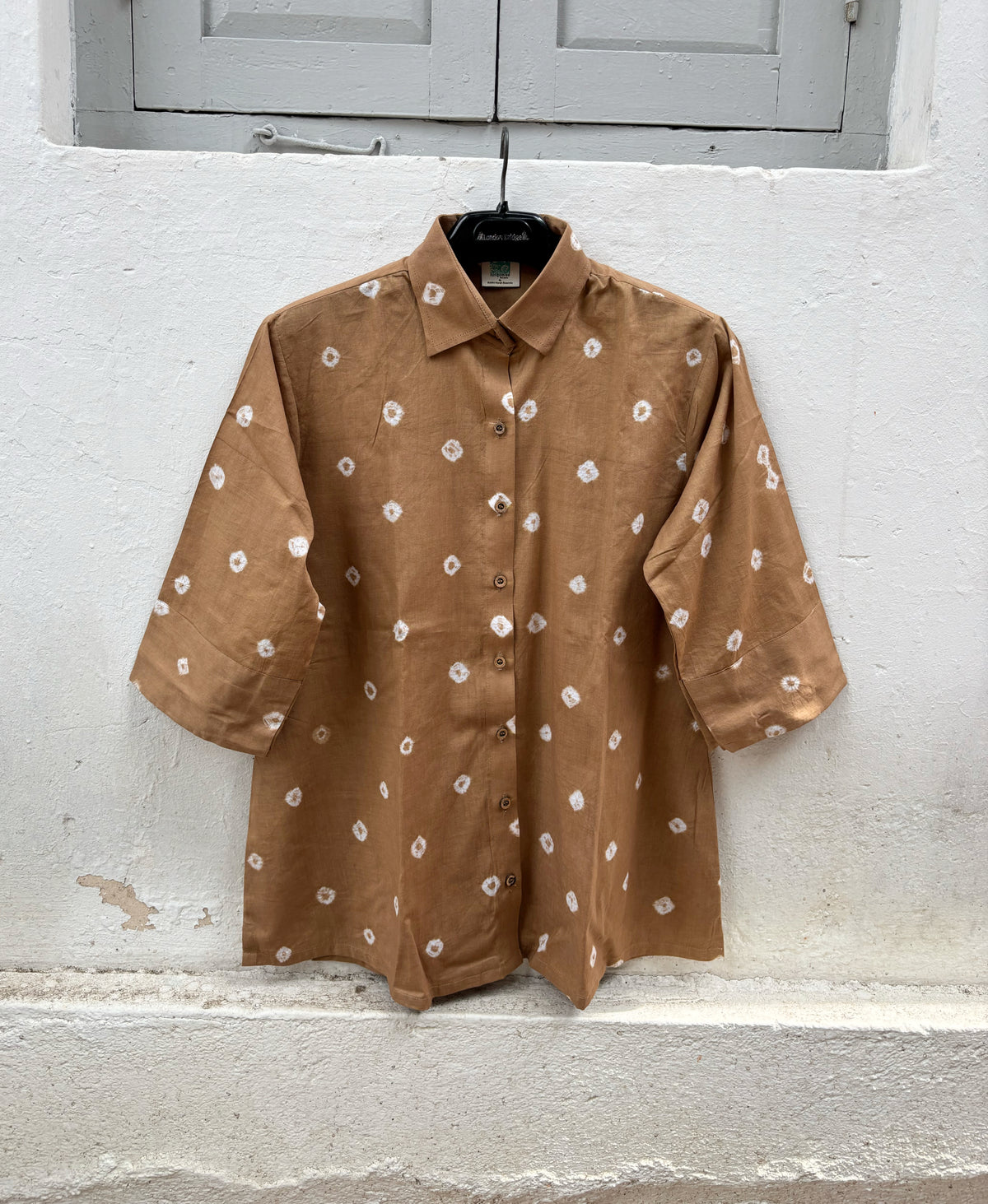 Women's camel brown cotton Bandhani shirt with wooden buttons.