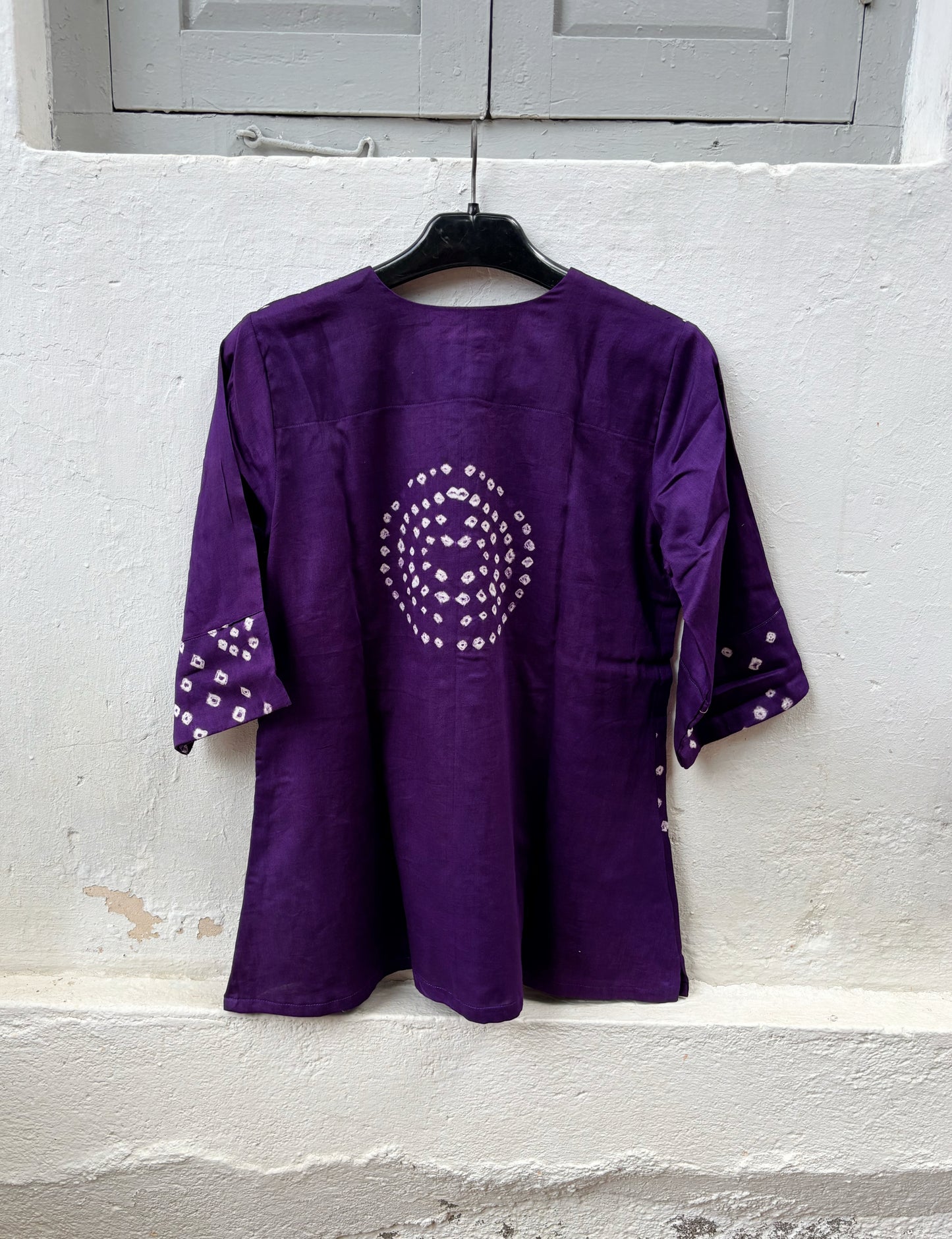 Deep Aubergine Cotton Satin Bandhani Shirt with hand tie-dyed geometric motifs, round neck, wooden buttons, relaxed fit, and elbow-length sleeves.