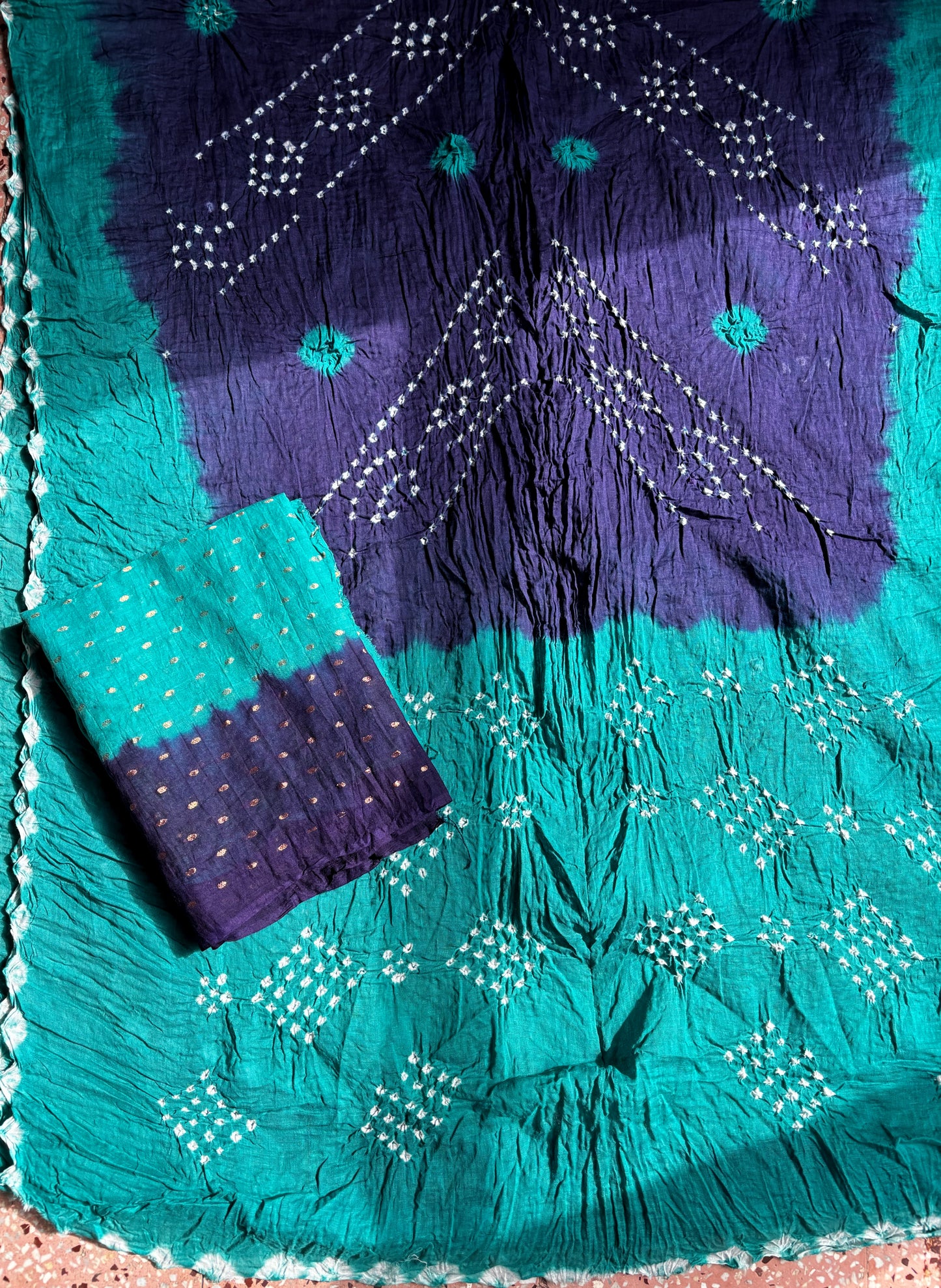Deep teal green and deep indigo hand tie-dyed Bandhani cotton saree with white floral and geometric dotted motifs