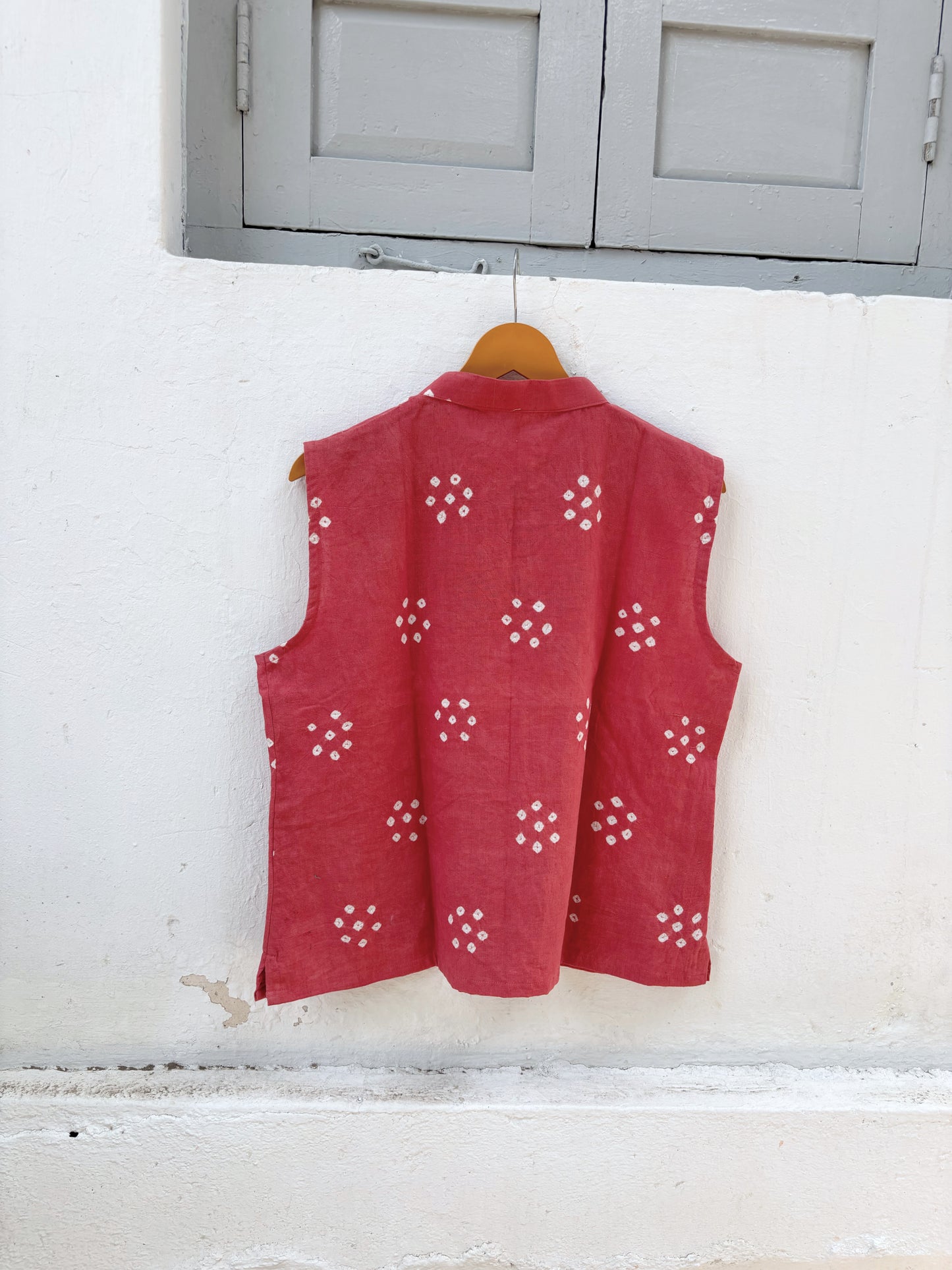 Dusty guava pink hand spun handwoven organic cotton Bandhani sleeveless shirt with white Bandhani butis and mandarin collar