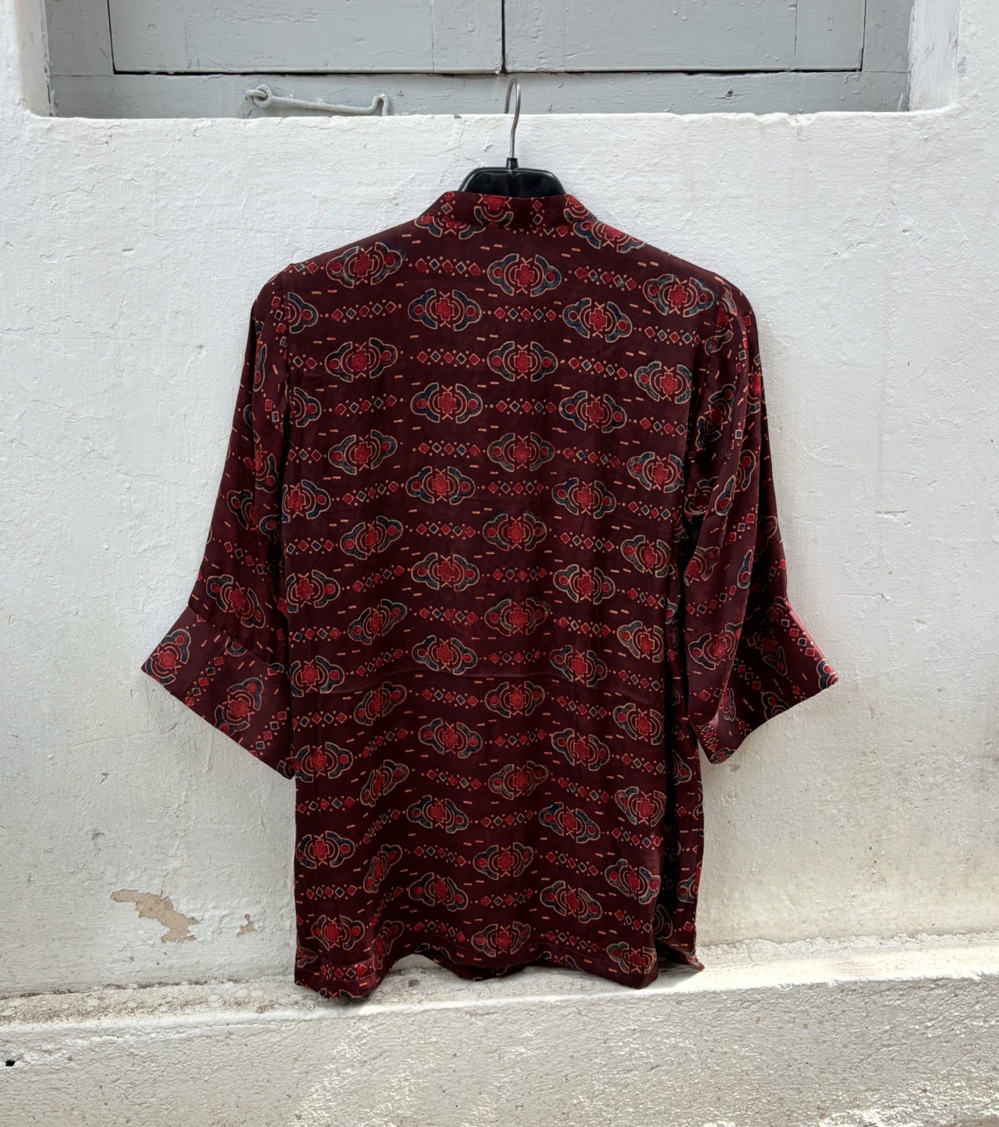 Back view of natural dyed Ajrakh hand block printed modal silk oversized shirt in deep wine maroon.