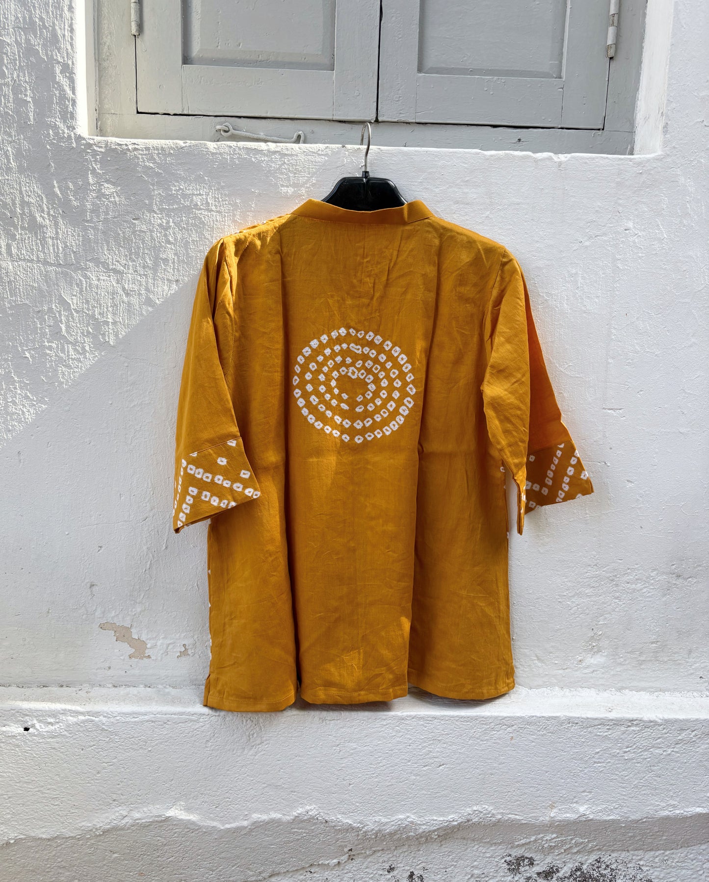 Golden Ochre hand tie-dyed Bandhani cotton satin shirt with handcrafted geometric motifs, soft mandarin collar and relaxed fit.