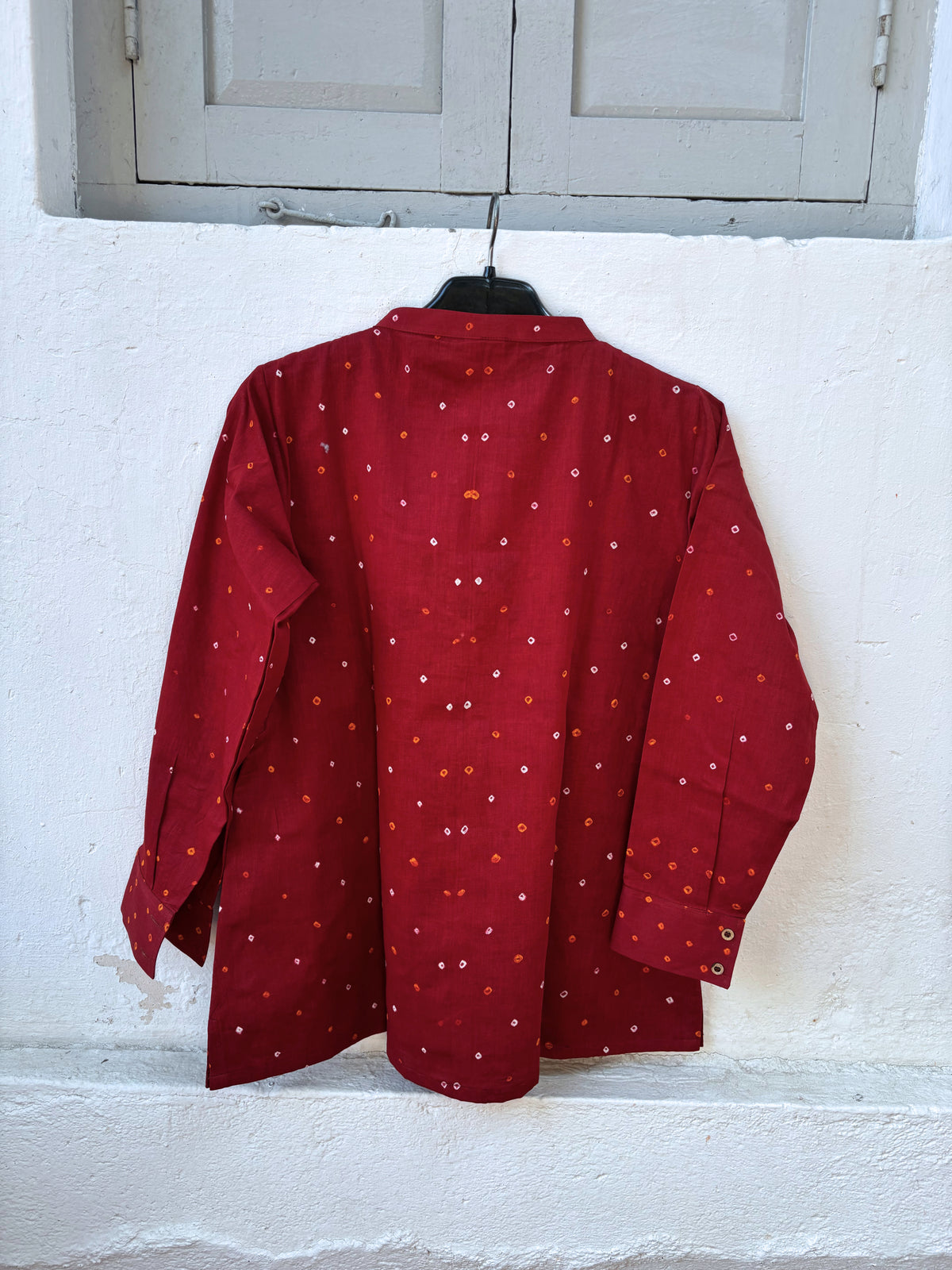 Jaswand deep red cotton shirt with turmeric-yellow and off-white hand tie-dyed Bandhani motifs, soft mandarin collar and partial button placket