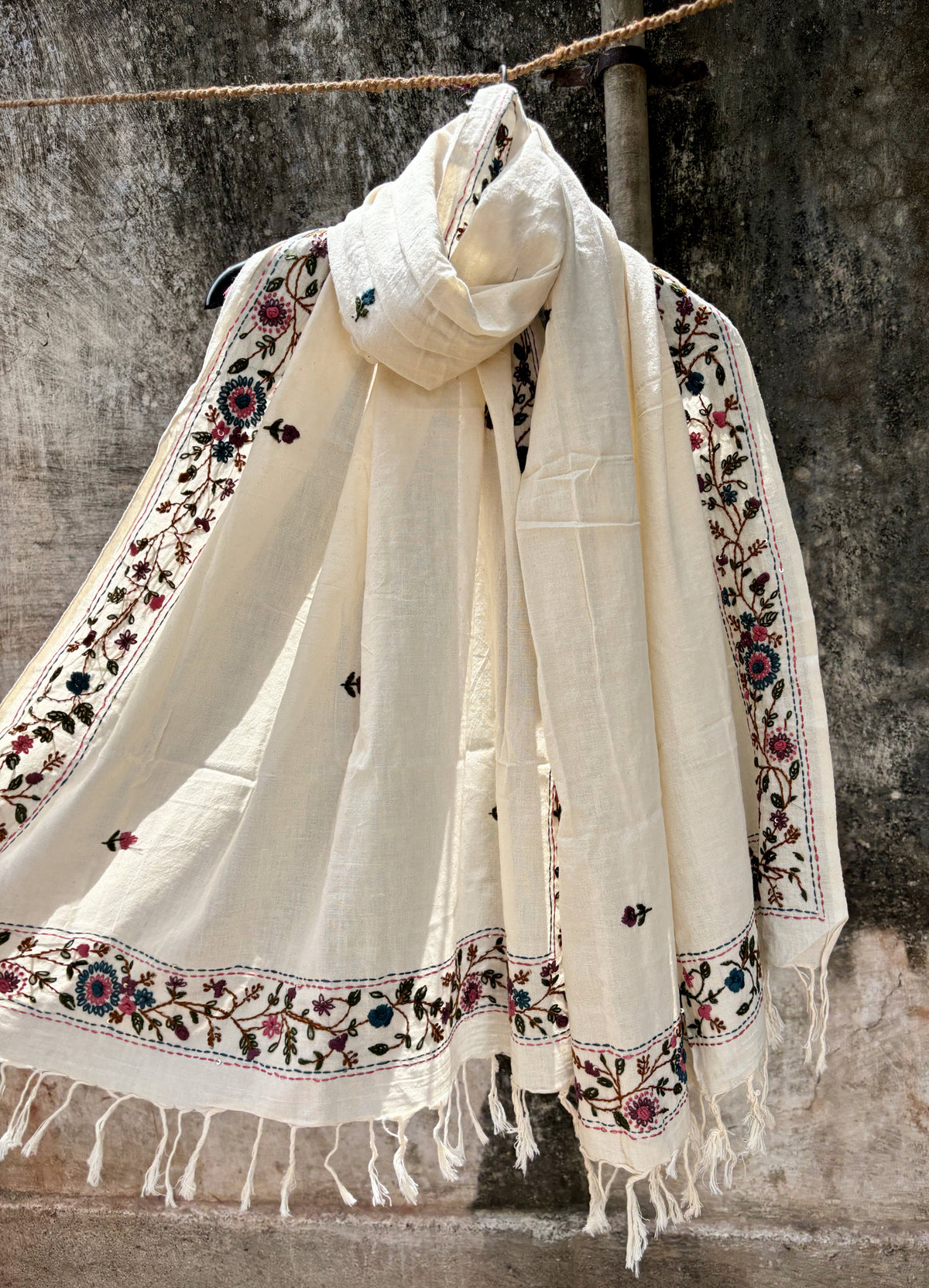 Juhi hand spun and handwoven off-white cotton dupatta with floral embroidered borders, scattered floral buds, and handcrafted tassels.