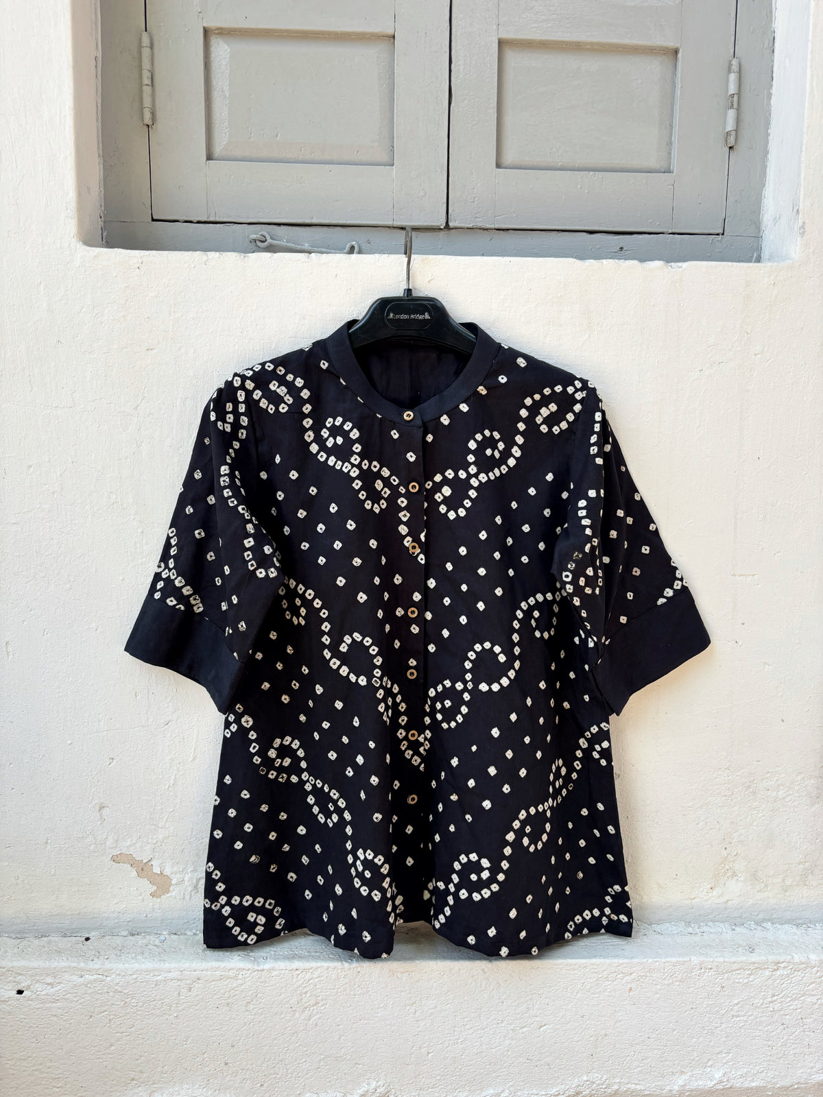 Woman’s black hand tie dyed Bandhani relaxed fit shirt in cotton satin with soft mandarin collar and ivory vine motifs