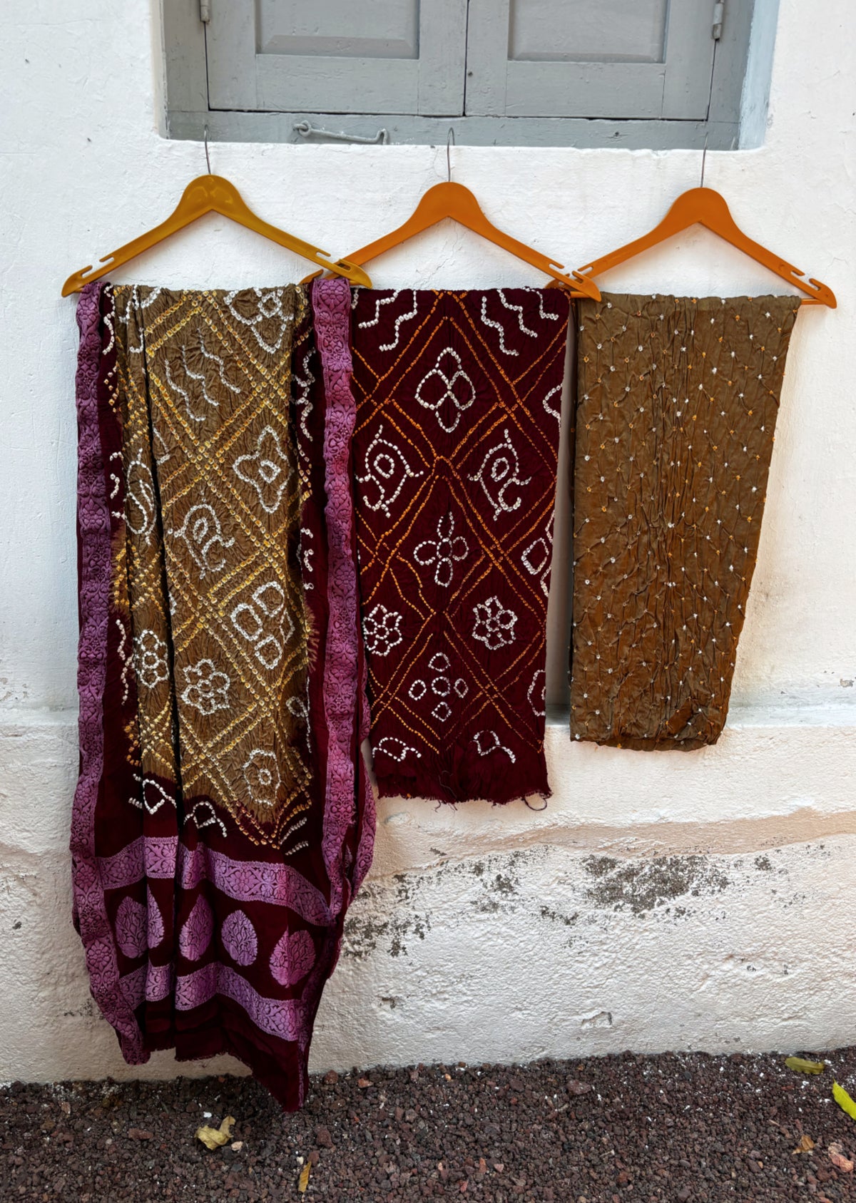 Three-piece Mahua modal silk Rai Bandhani unstitched suit set in deep wine and earthy brown with off-white and mustard-gold tie-dye detailing and matching dupatta