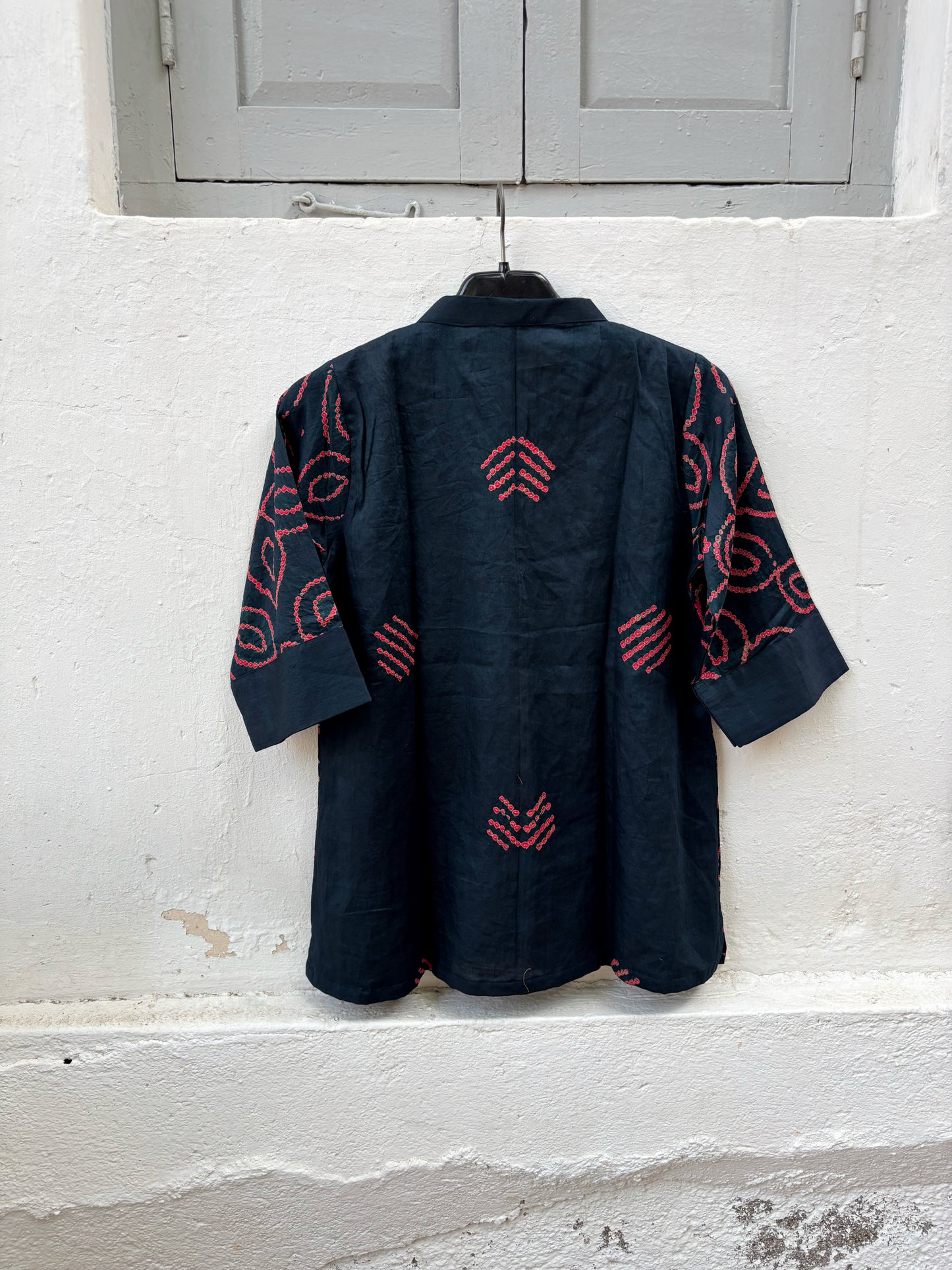 Midnight navy blue Jhankar Bandhani cotton shirt with raspberry rose floral motifs, soft mandarin collar, folded sleeve cuffs, coconut shell buttons and relaxed fit.