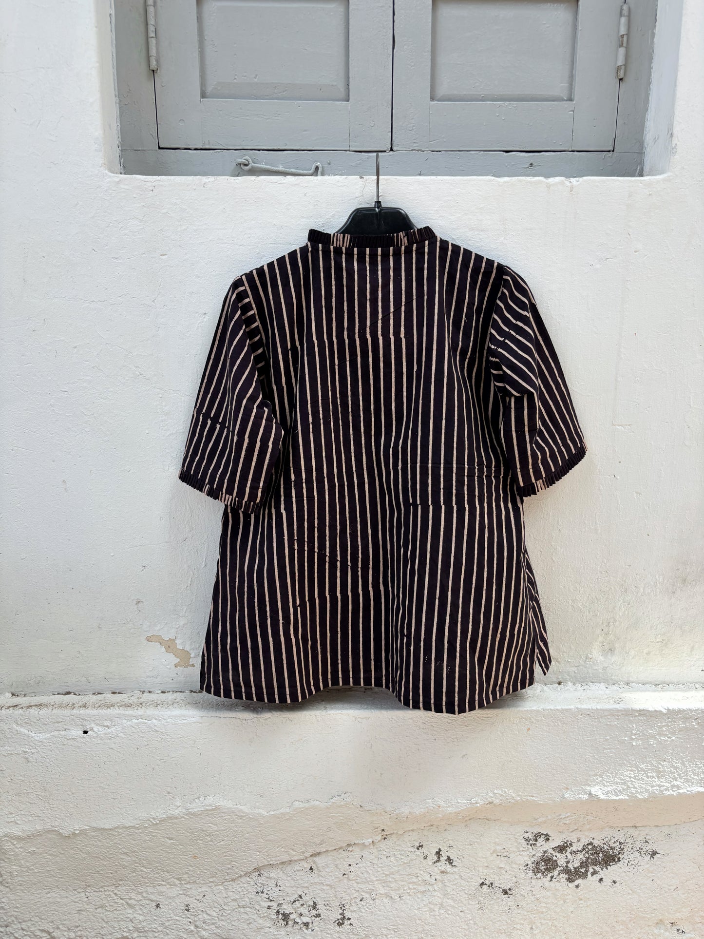 Ajrakh hand block printed cotton shirt with natural dyed beige stripes on a deep midnight base, pleated neckline, pleated sleeve hems and relaxed fit.