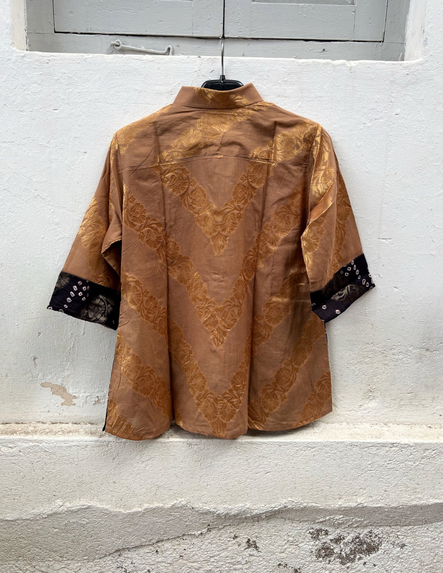Handcrafted Bandhani festive cotton shirt in Earth Brown, Rustic Crimson and Classic Black with antique gold woven floral motifs, classic shirt collar, front button closure, relaxed fit and three-quarter sleeves.