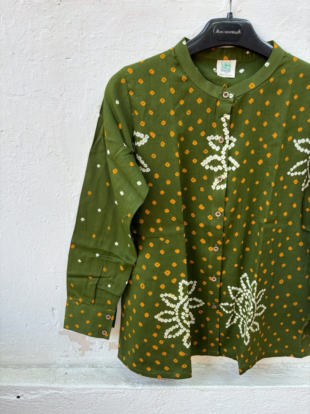 Olive green cotton shirt with turmeric yellow and off-white Bandhani floral motifs, mandarin collar and front-open button closure