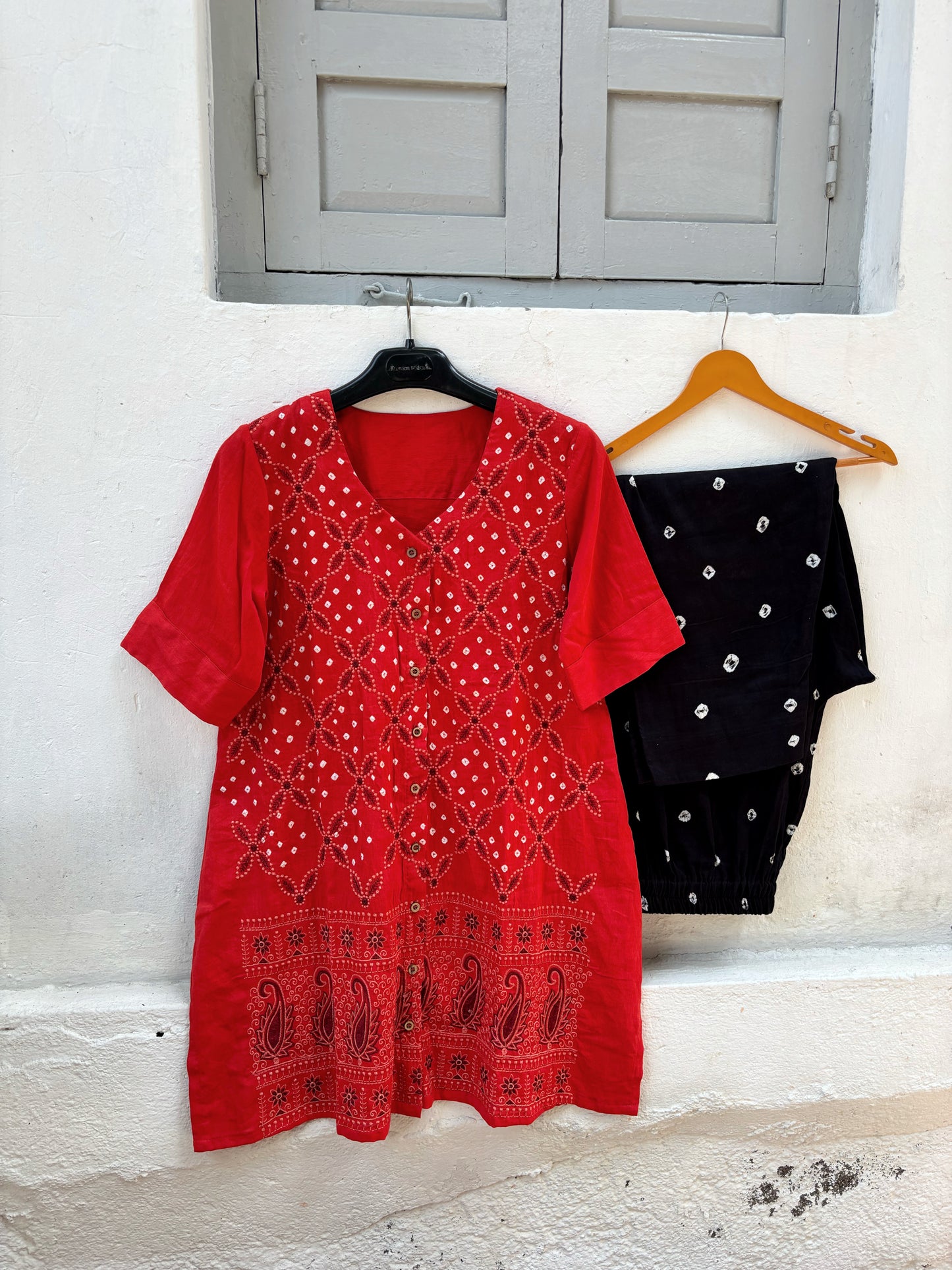 Orange and black Bandhani three-piece set for women with embroidered kurta, comfortable-fit pants and hand tie dyed dupatta
