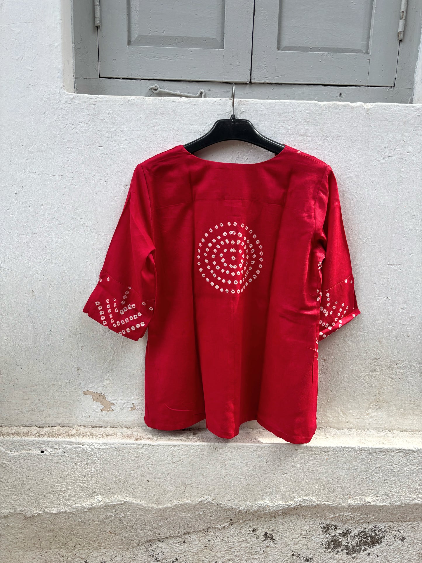 Handcrafted sindoor red Bandhani top featuring chevron-inspired tie-dye motifs.