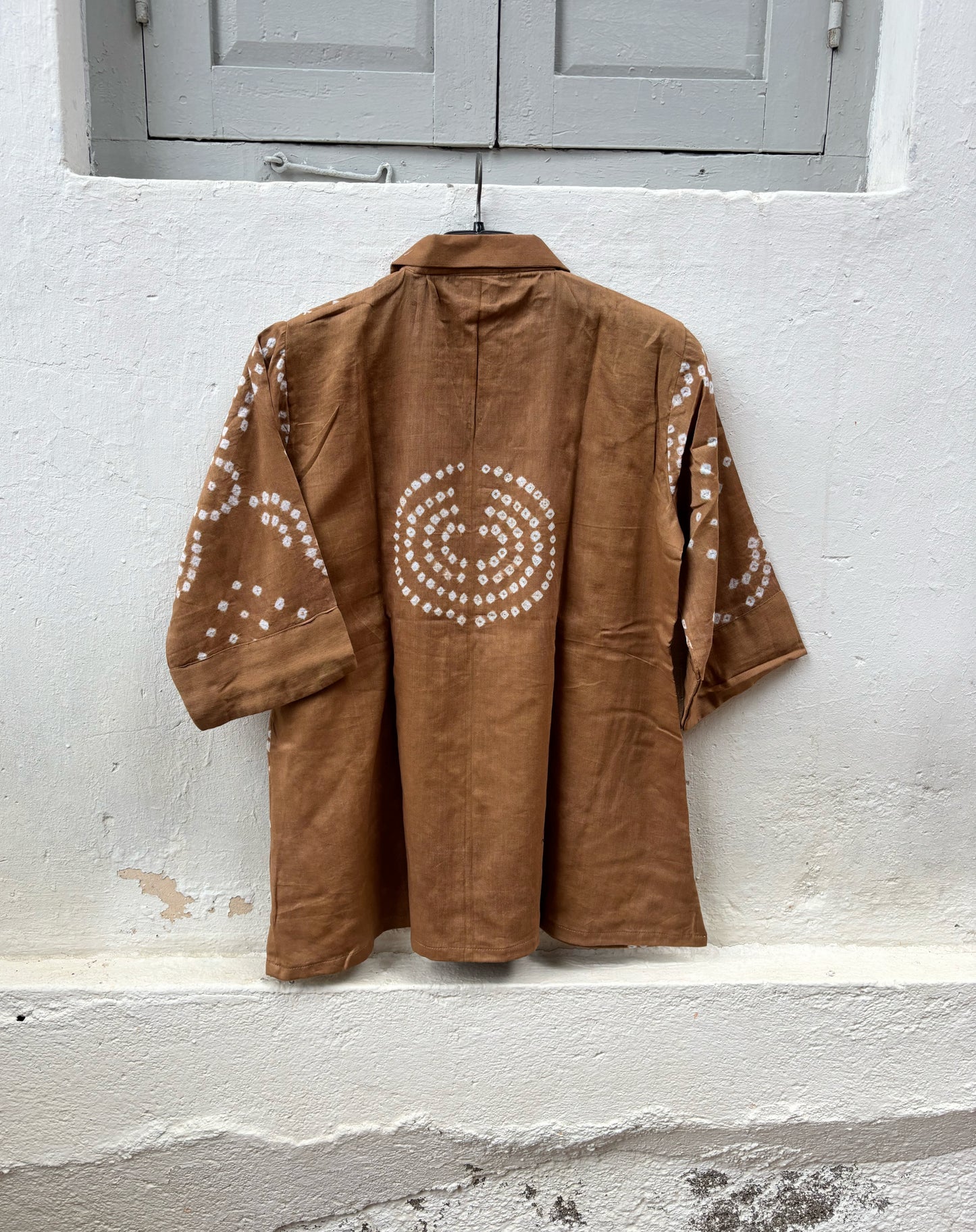 Back view of Toffee Brown Cotton Satin Bandhani Shirt featuring a circular Bandhani motif and handcrafted geometric tie-dyed details.