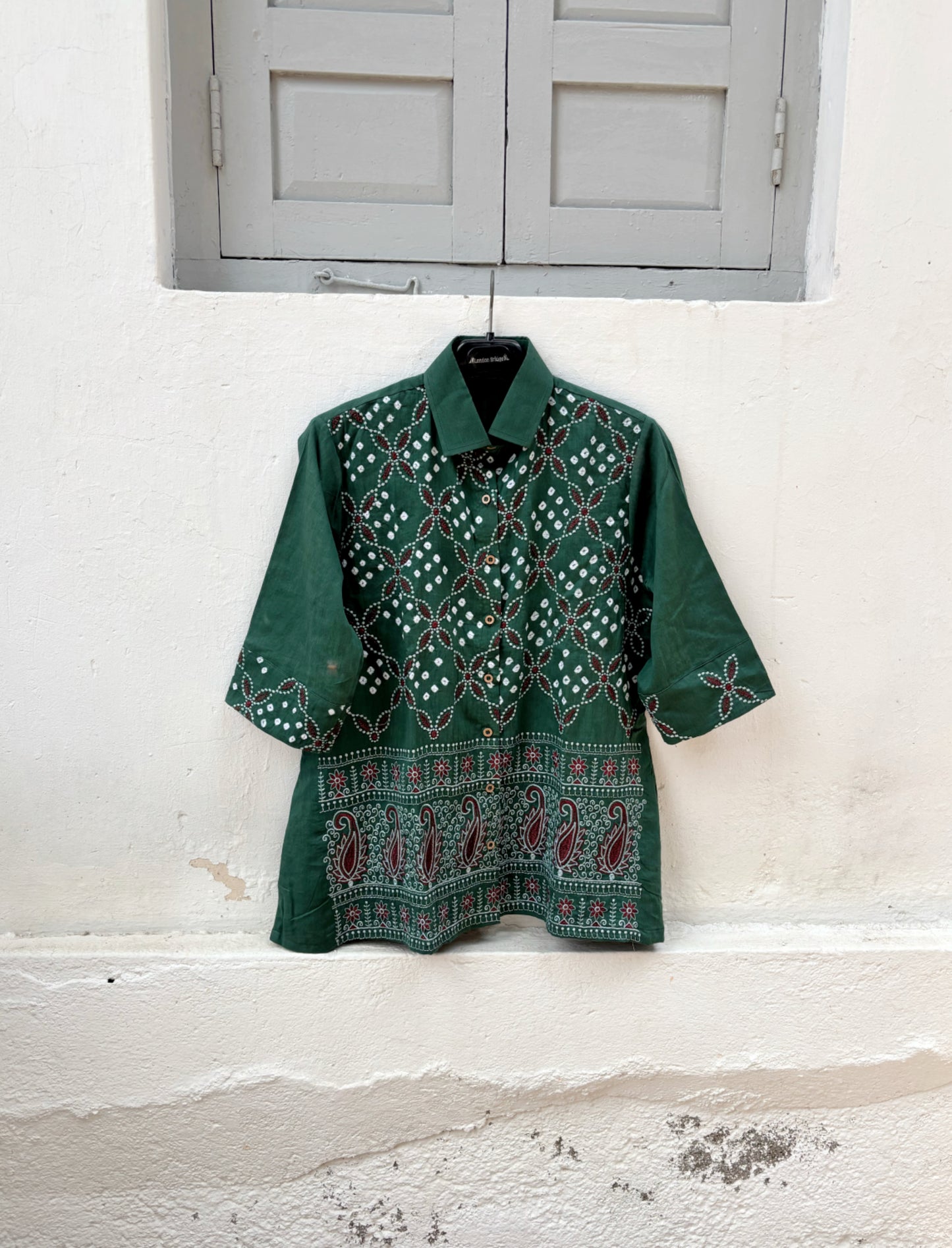 Forest green cotton satin Bandhani shirt with intricate machine embroidery, paisley border detailing, classic shirt collar and relaxed fit silhouette.