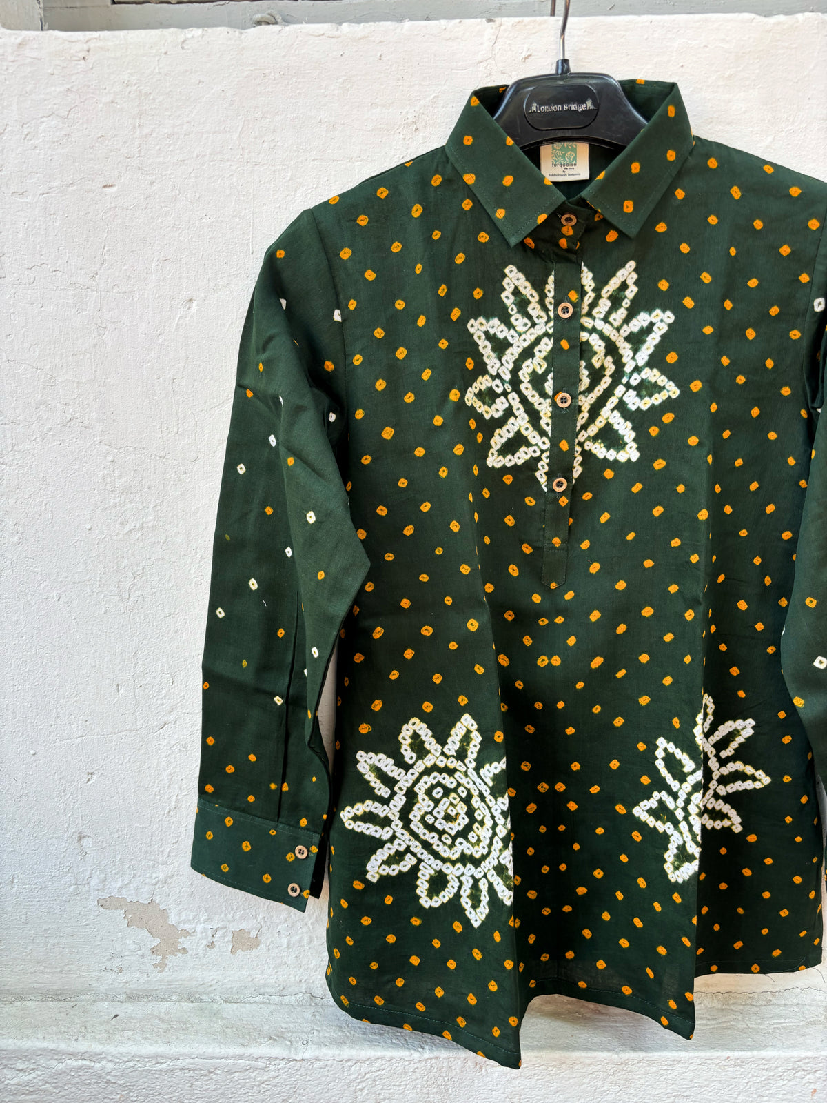 Vanrai deep green cotton shirt with turmeric-yellow Bandhani dots and off-white floral motifs on the front