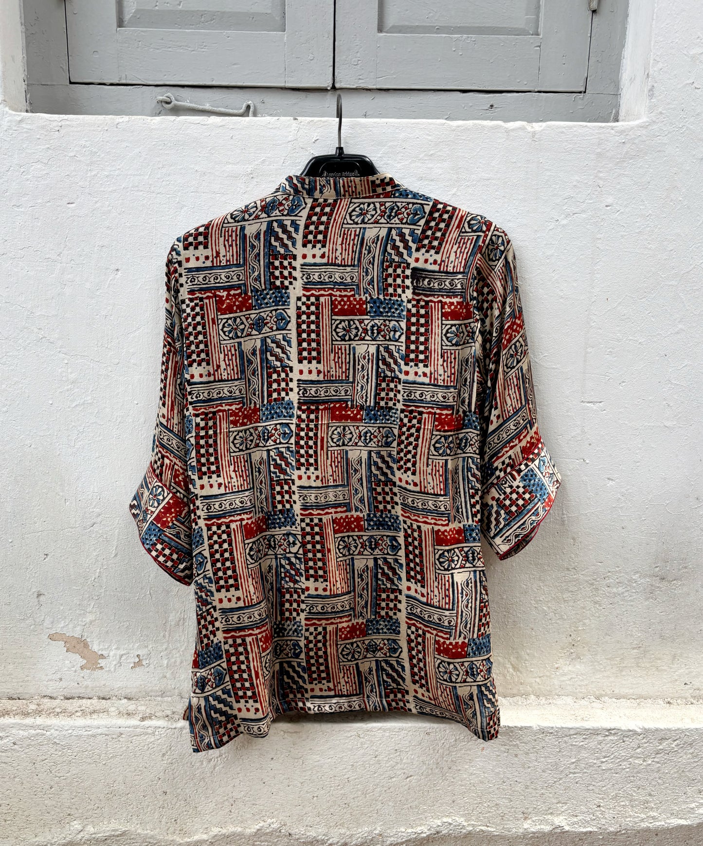 Natural dyed Ajrakh hand block printed modal silk oversized shirt for women in myrobalan beige with indigo blue and madder red geometric motifs.