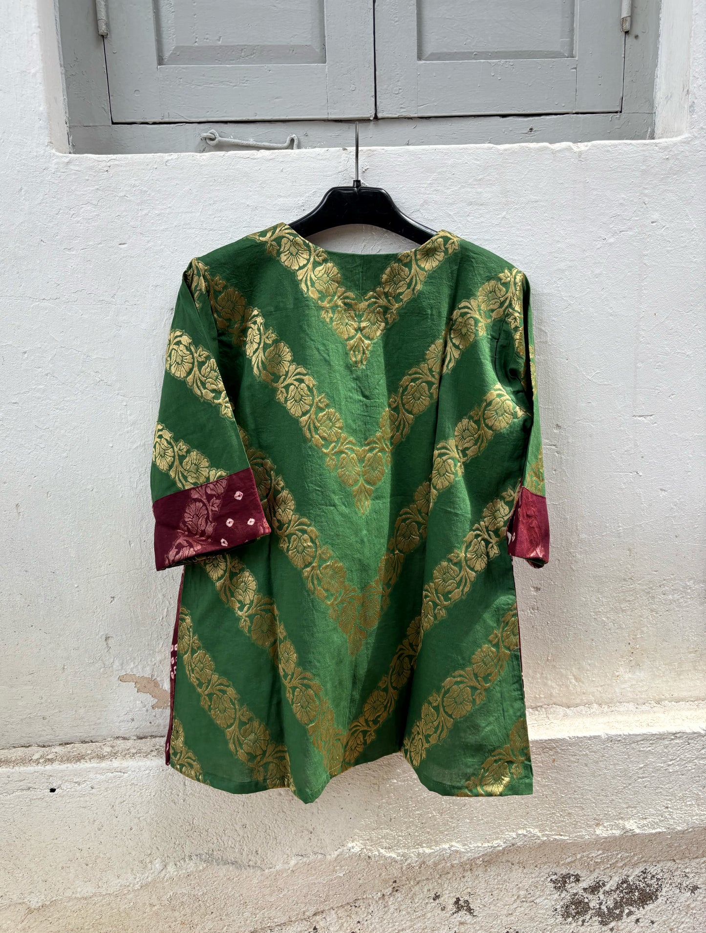 Handcrafted Bandhani festive cotton top in Forest Green, Rust Ochre and Wine Maroon with antique gold woven floral motifs, V-neck, relaxed fit and three-quarter sleeves.