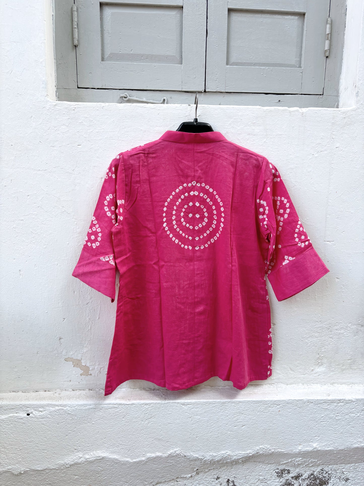 Hand tie-dyed Bandhani cotton satin shirt in Wild Rose Pink with white handcrafted Bandhani motifs, soft mandarin collar and relaxed fit.