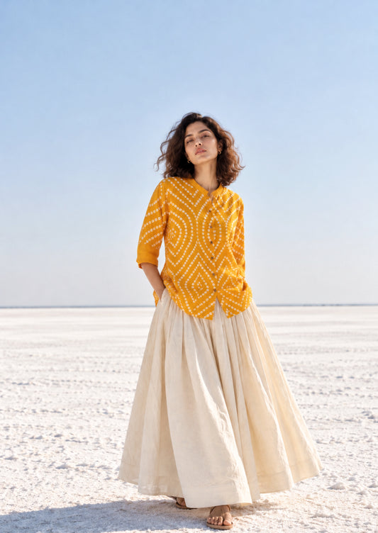 Aamras mango-yellow cotton satin shirt with ivory hand tie-dyed Bandhani patterns, soft mandarin collar and button-down front.