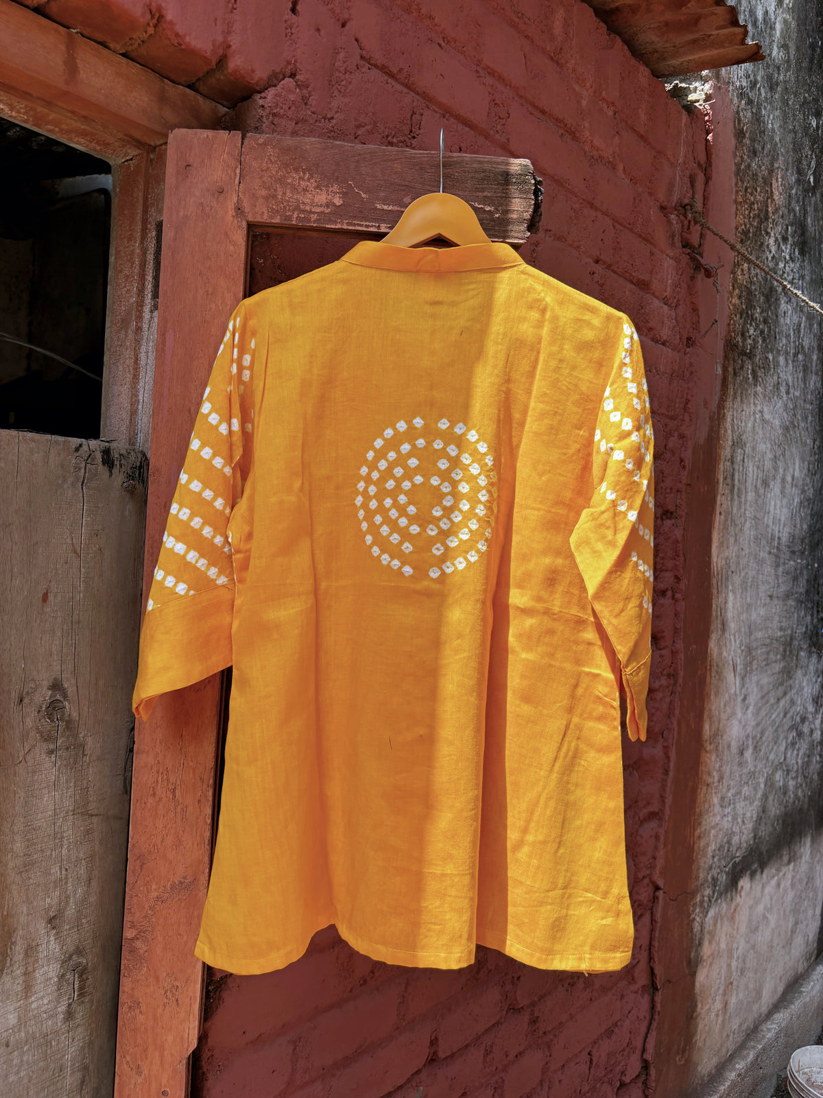 Aamras mango-yellow cotton satin shirt with ivory hand tie-dyed Bandhani patterns, soft mandarin collar and button-down front.