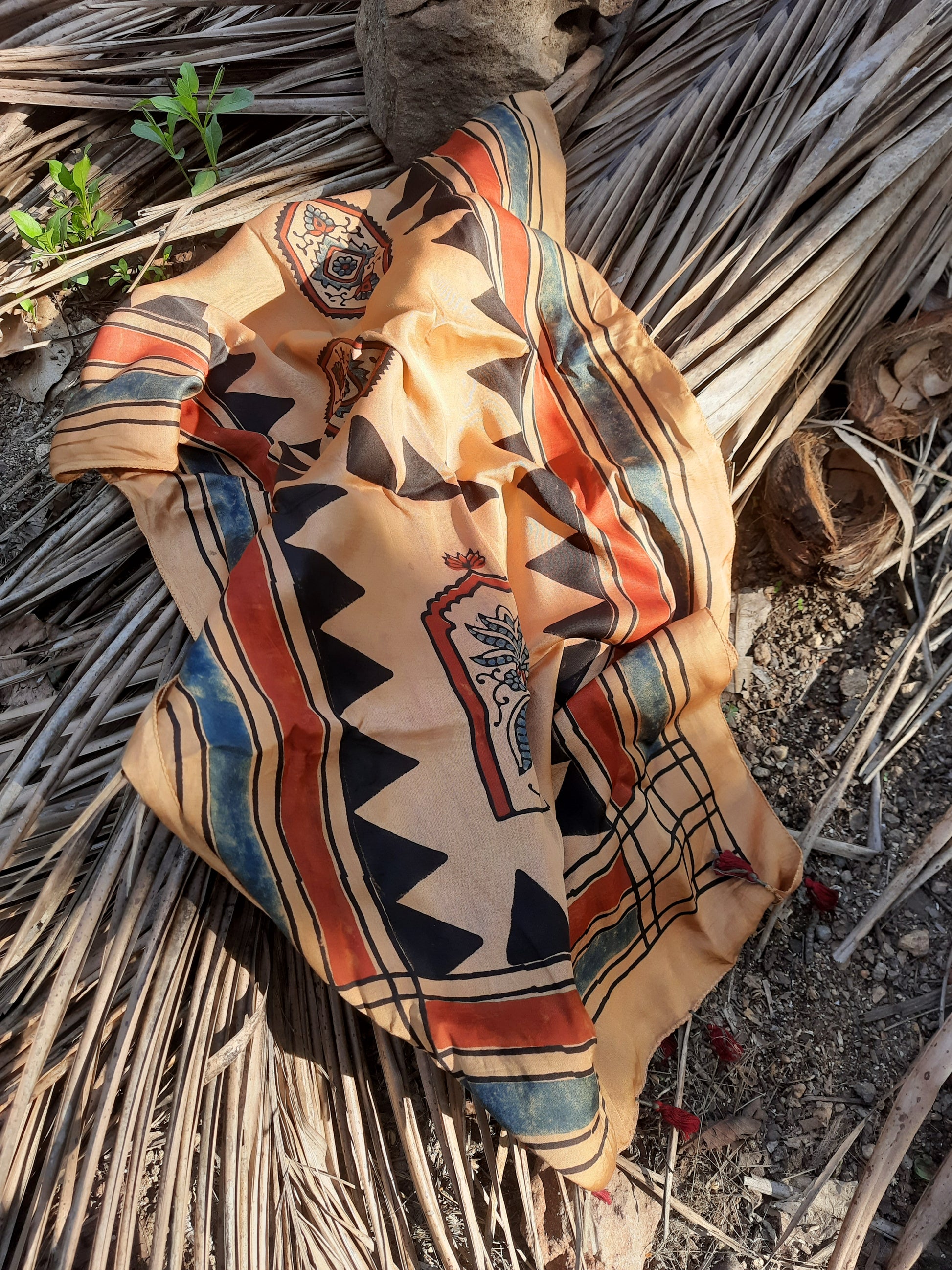 Earthy peach Ajrakh modal silk stole handcrafted with multiple hand block prints, naturally dyed with seasonal flowers, featuring a soft drape and tassels on both ends. Artisanal, sustainable, and one-of-a-kind.