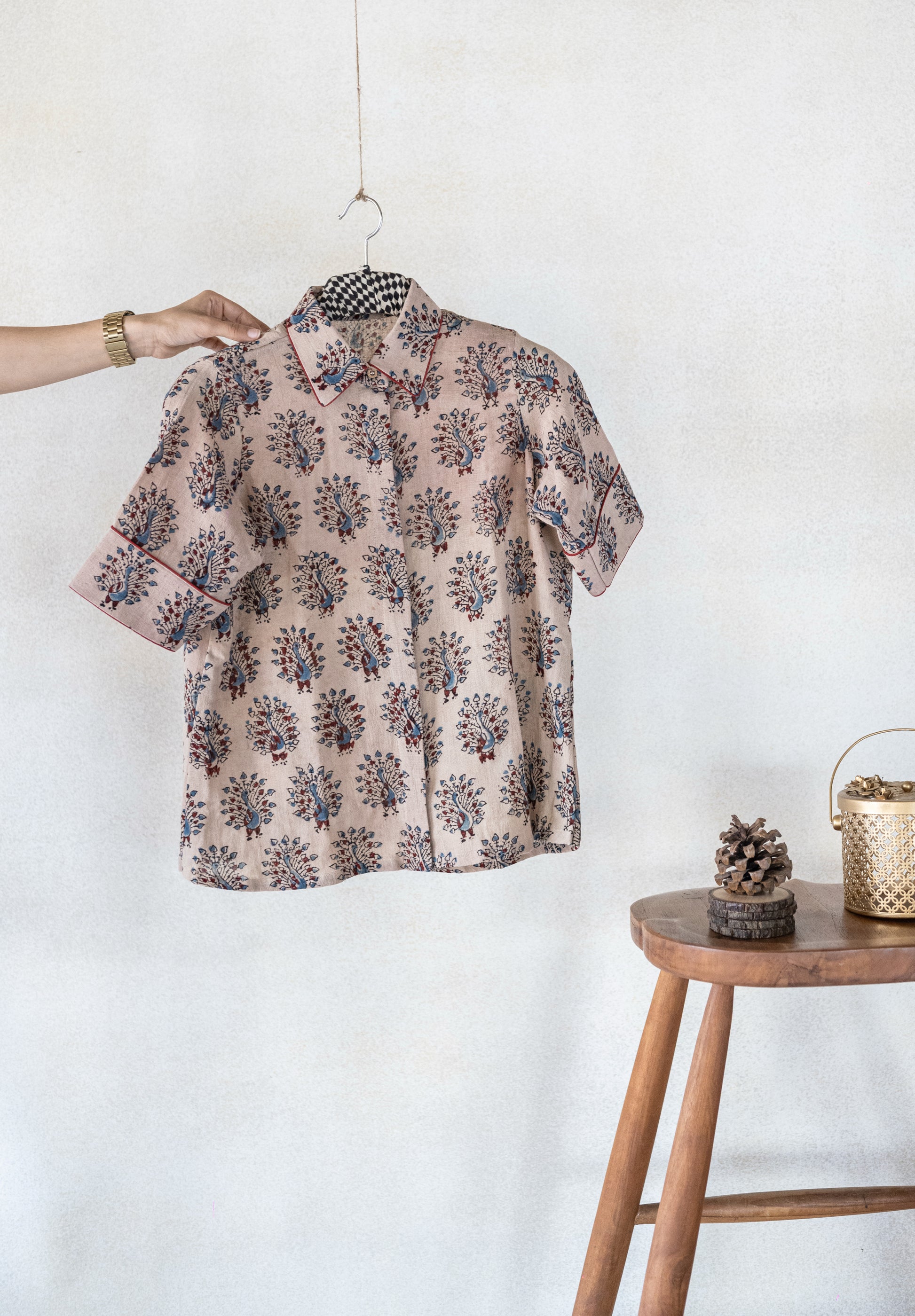 Hand spun and handwoven organic cotton beige Ajrakh hand block printed shirt for women featuring peacock motif and madder dyed piping on collar and cuffs, naturally dyed and crafted for breathable everyday comfort.