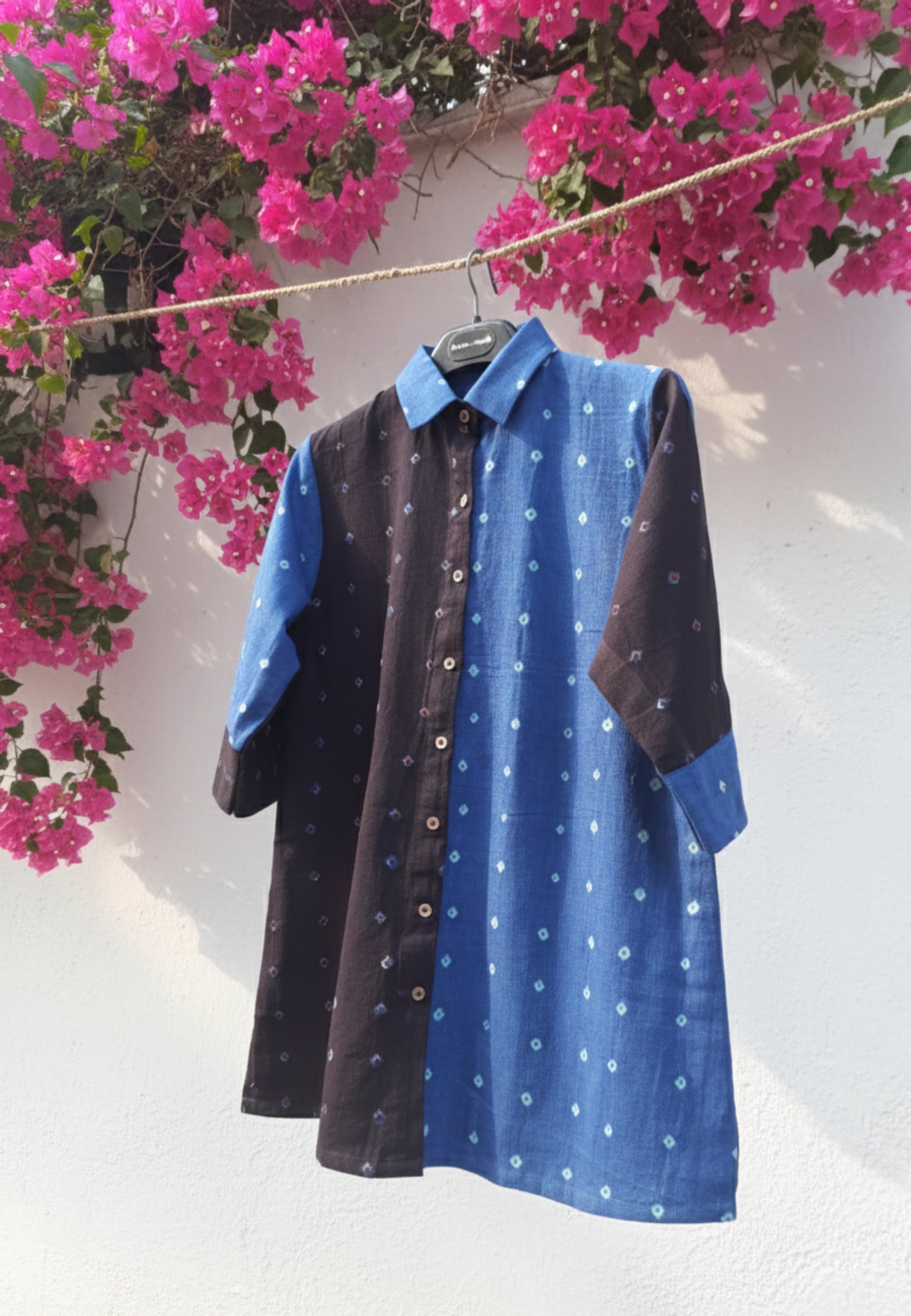 Blue and black half-and-half Bandhani oversized shirt crafted in organic cotton, featuring hand tie dyed patterns on both panels. Relaxed oversized fit, breathable and slow made women’s shirt handcrafted using traditional Bandhani techniques in India.