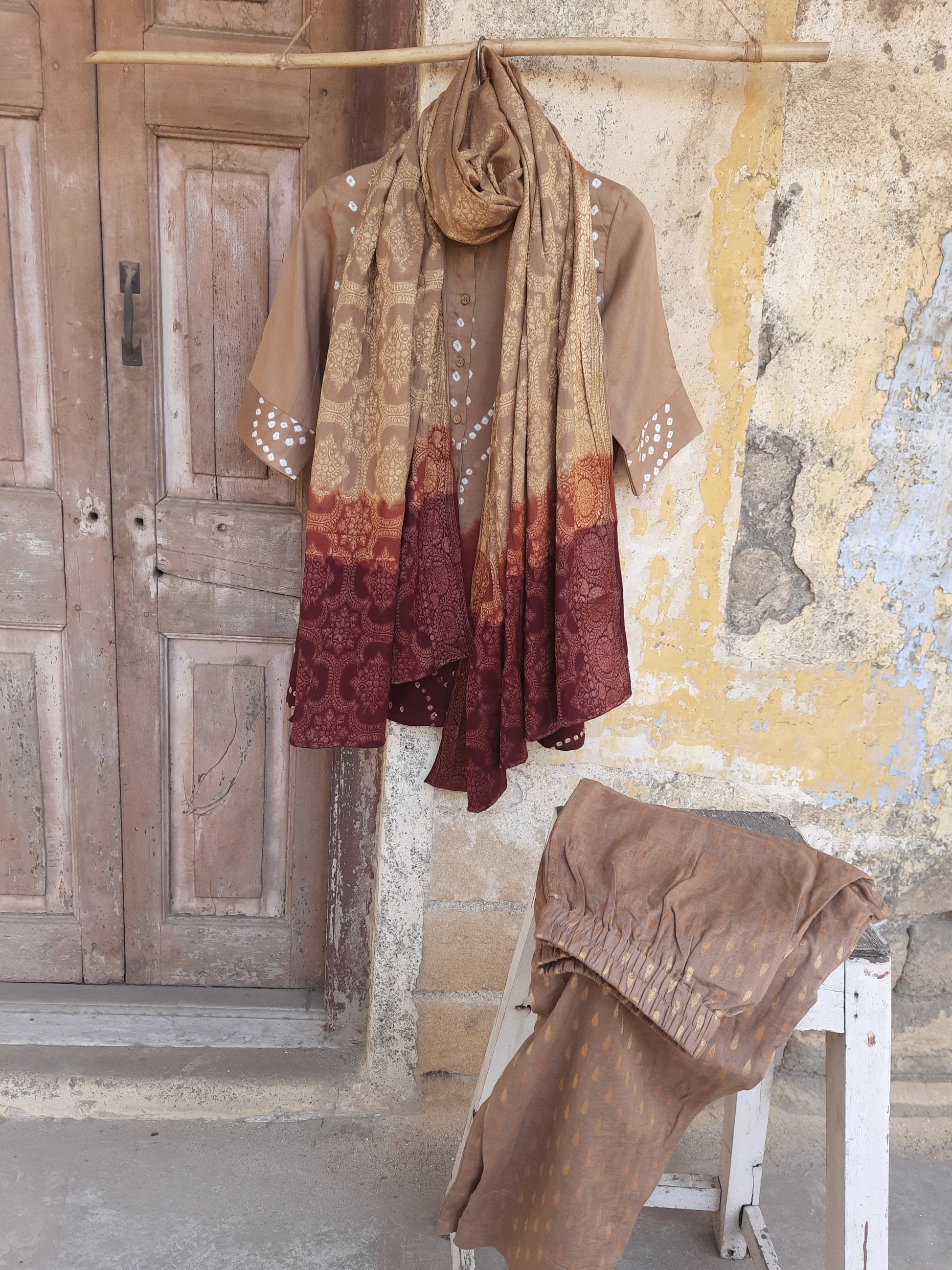 Hand tie dyed Bandhani cotton satin shirt in beige with rust and maroon detailing paired with jacquard pants and Banarasi weave dupatta