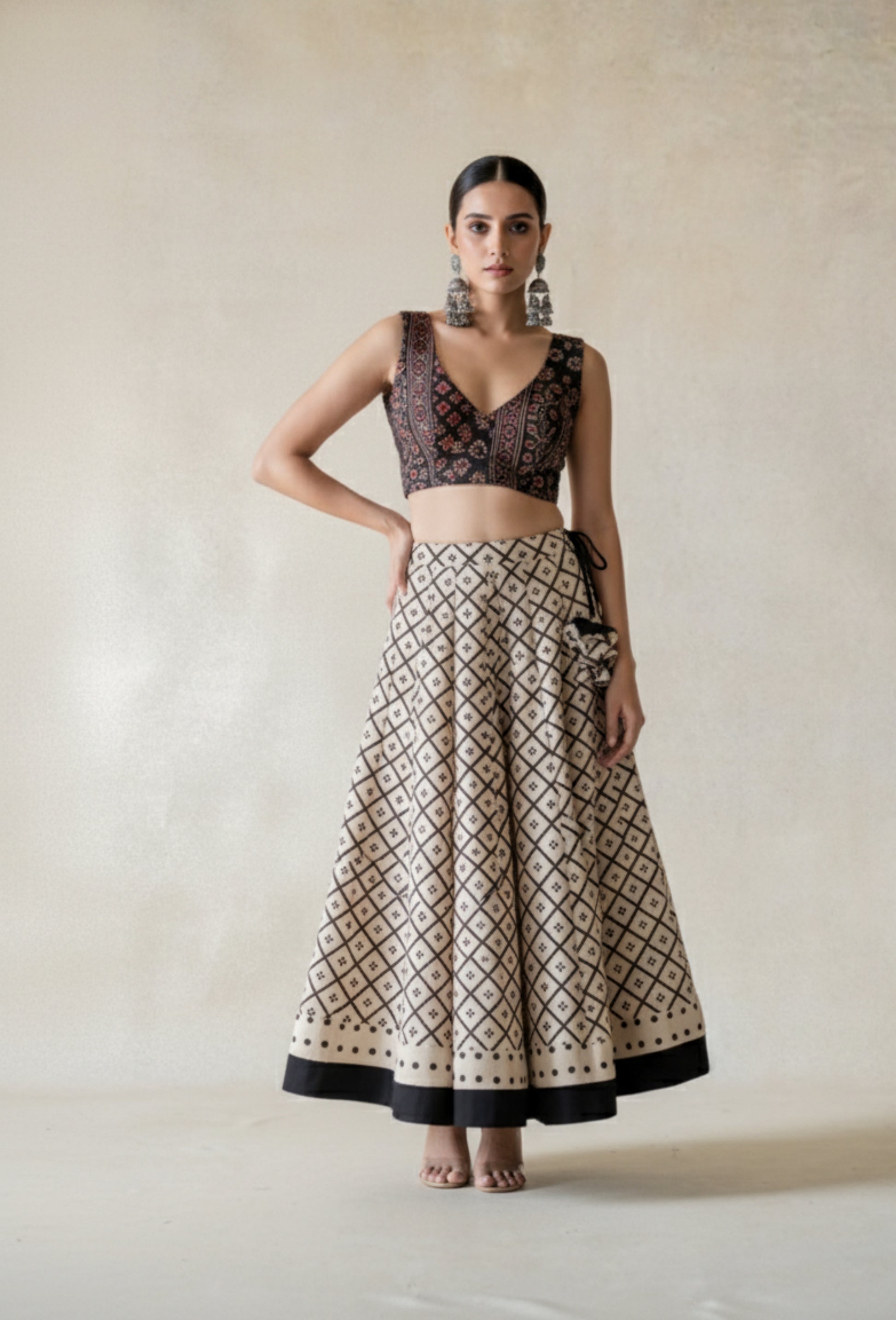 Beige natural dyed Ajrakh hand block printed kali-cut skirt with borders, side zip and drawstring. Handmade slow-made cotton skirt styled with a black Ajrakh blouse.