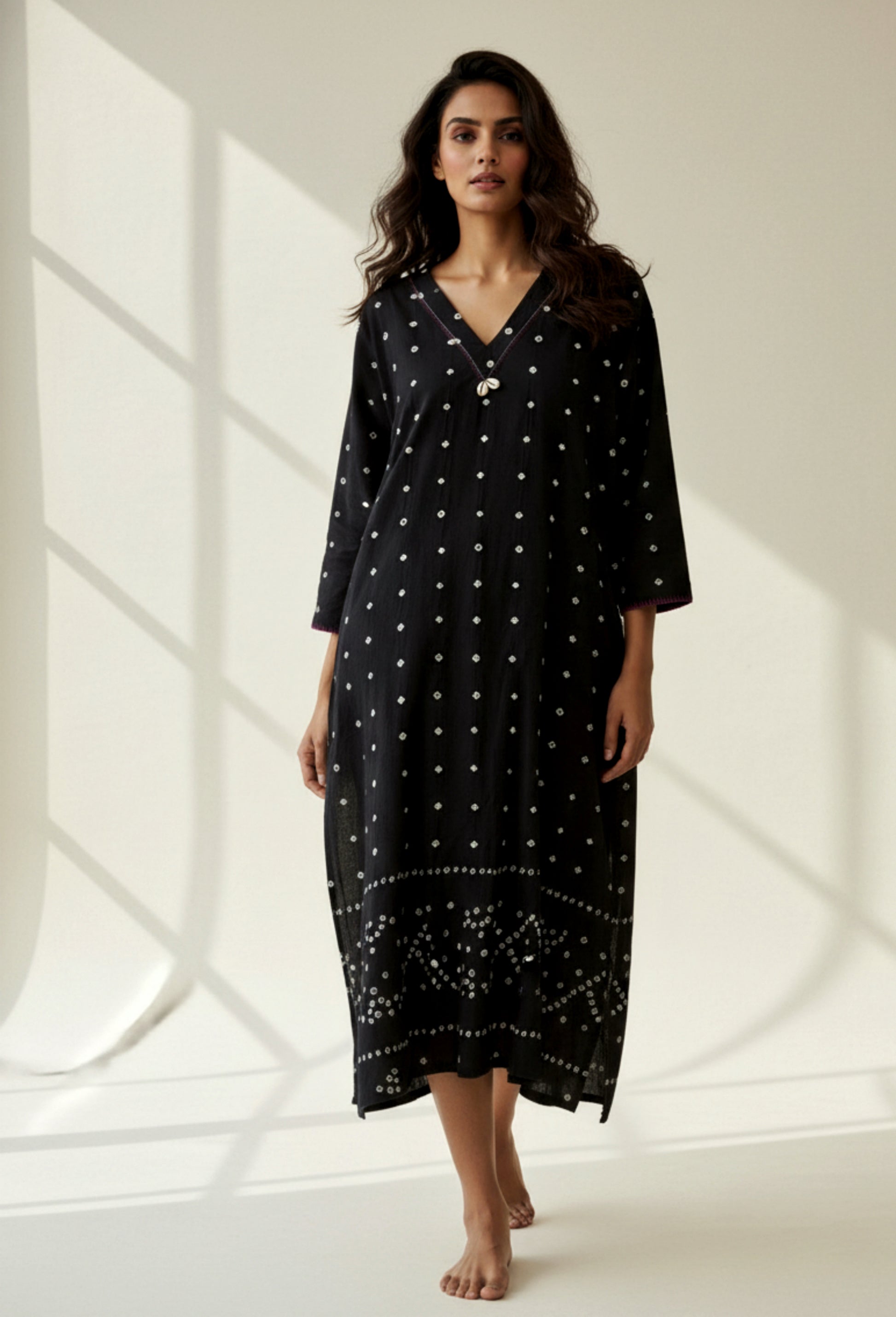 Handwoven organic cotton oversized Bandhani kurta for women with V-neck, cowrie detailing, full sleeves, and hand tie-dyed design handcrafted by artisans of Gujarat.