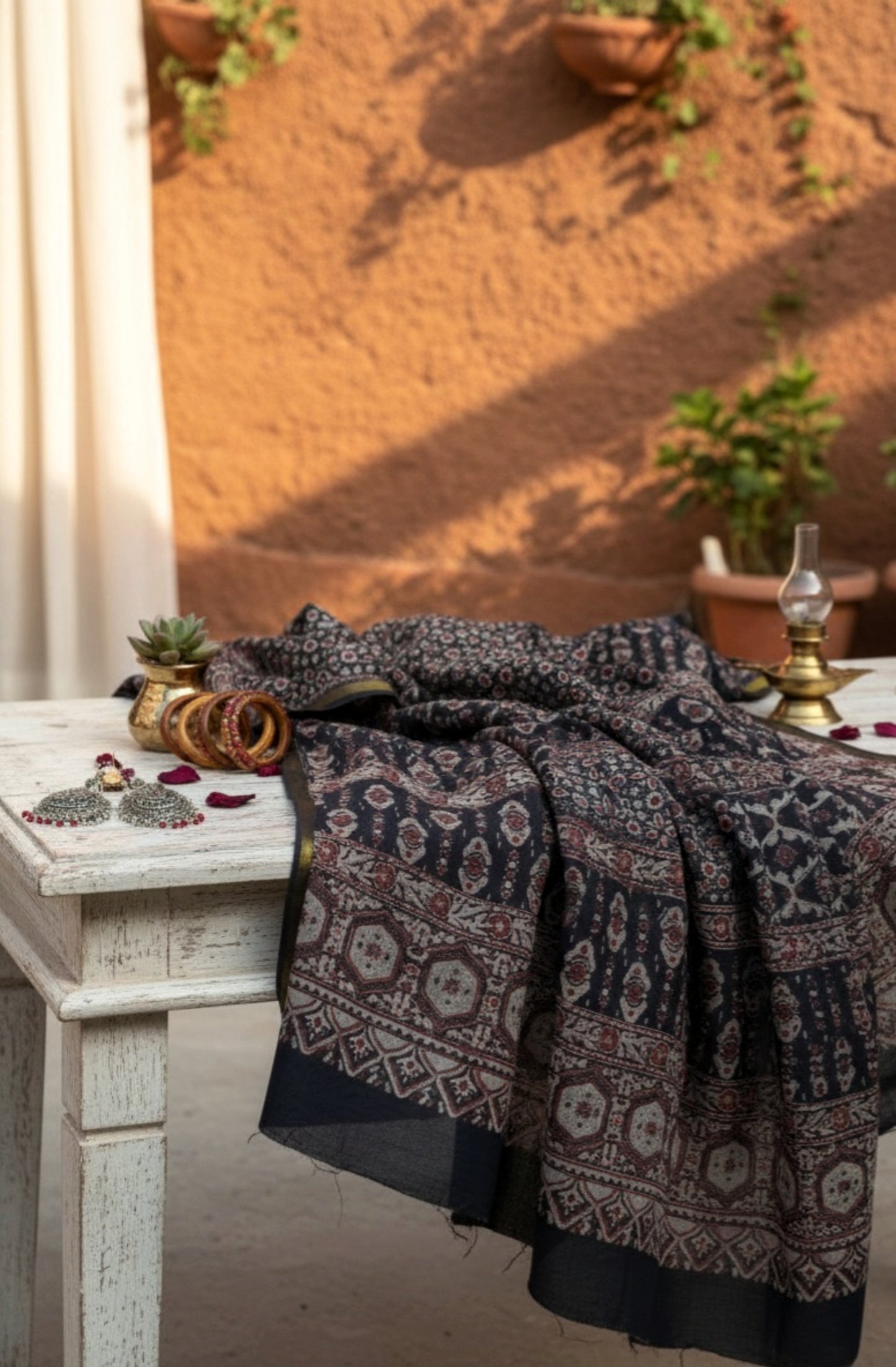 Black Ajrakh hand block printed pure cotton saree featuring traditional natural-dyed motifs and detailed Ajrakh border. Slow made, handmade saree measuring 6.30 meters with a 44-inch width.