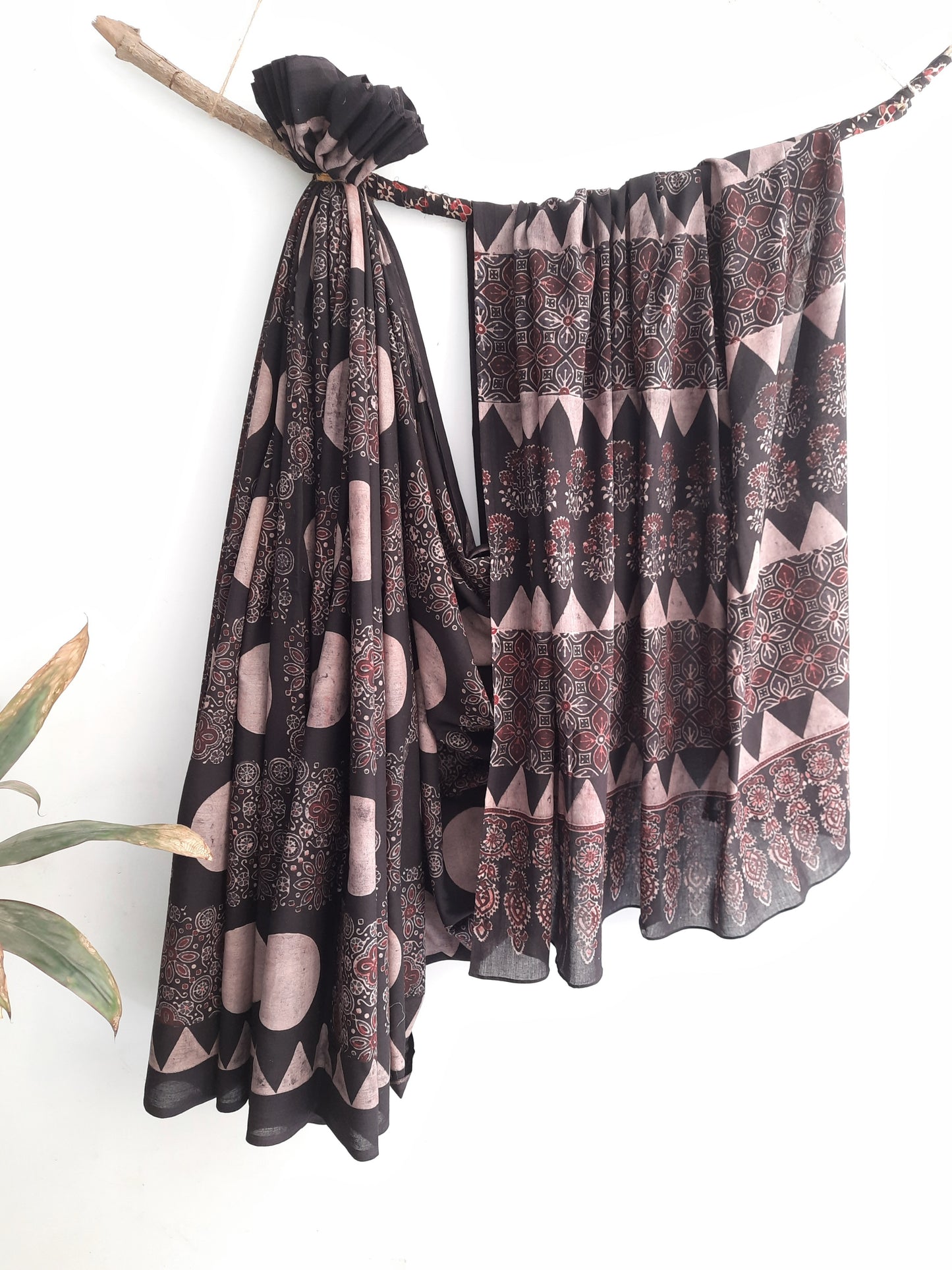 Black natural dyed Ajrakh hand block printed cotton saree crafted using cosmic moon motifs and traditional wooden hand blocks. Pure cotton, breathable, slow made saree with running blouse piece, handmade by artisans in Gujarat.