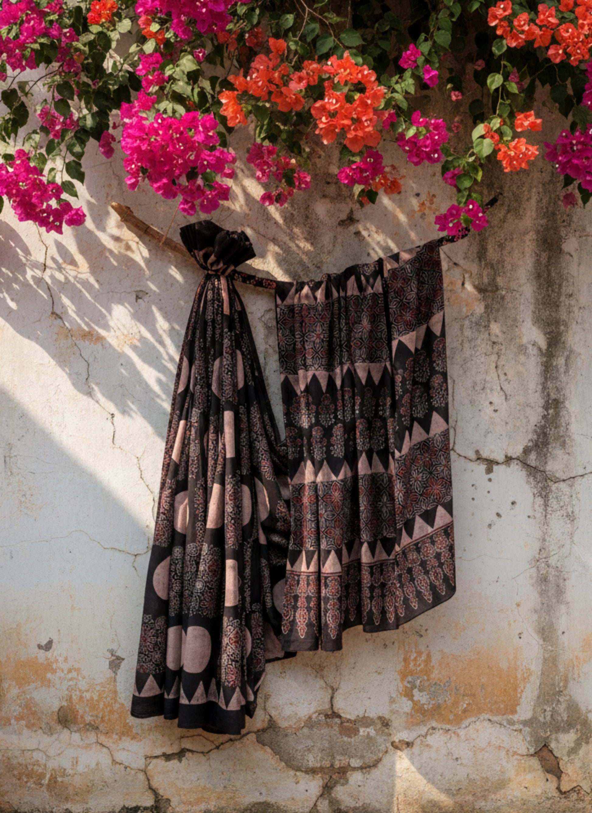 Black natural dyed Ajrakh hand block printed cotton saree crafted using cosmic moon motifs and traditional wooden hand blocks. Pure cotton, breathable, slow made saree with running blouse piece, handmade by artisans in Gujarat.