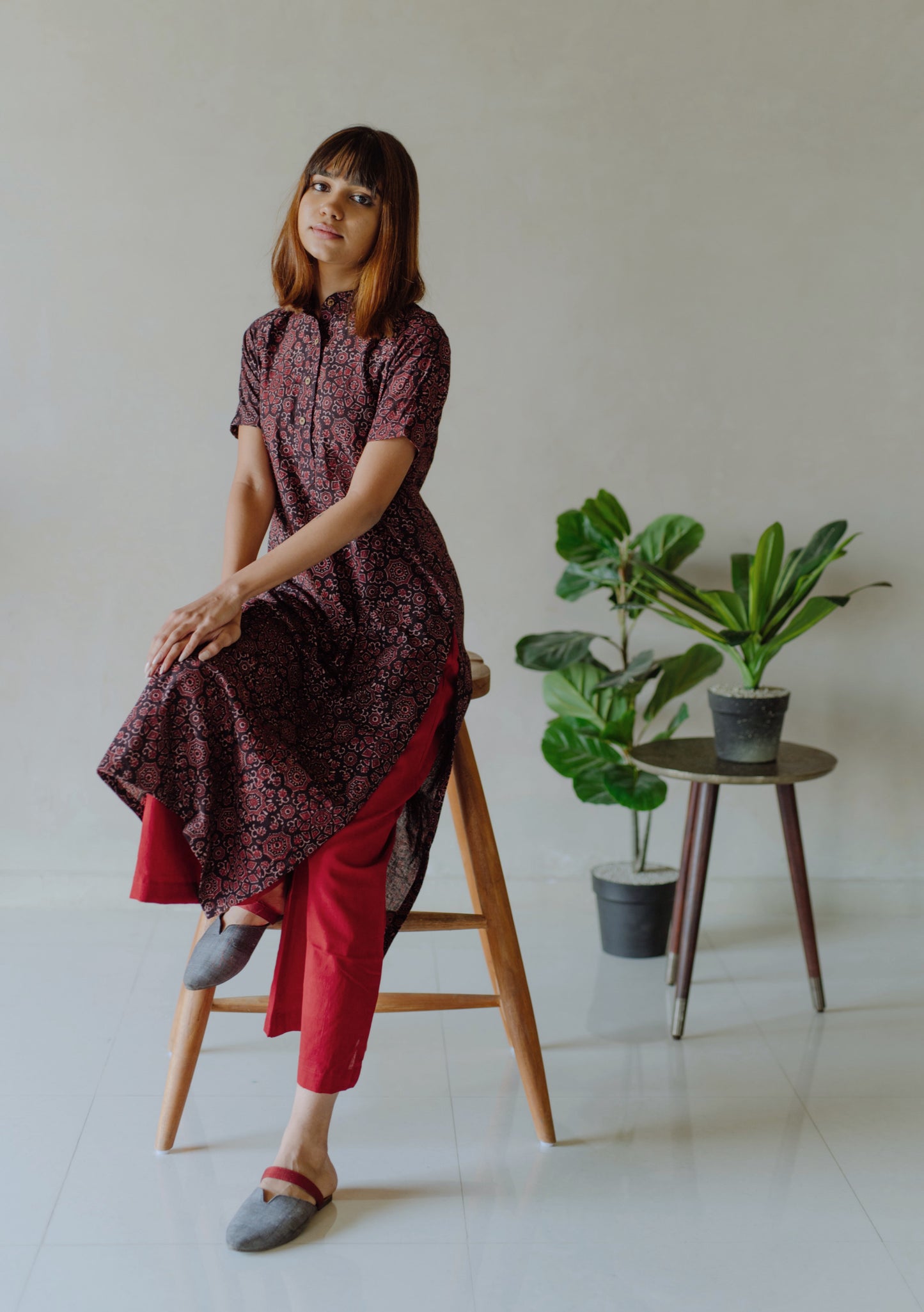 Natural black Ajrakh hand block printed cotton kurta with mandarin collar paired with madder red naturally dyed cotton pants featuring elasticated waist. Handmade, breathable, slow made Indian wear crafted by artisans in Gujarat.