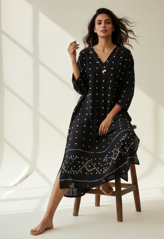 Handwoven organic cotton oversized Bandhani kurta for women with V-neck, cowrie detailing, full sleeves, and hand tie-dyed design handcrafted by artisans of Gujarat.