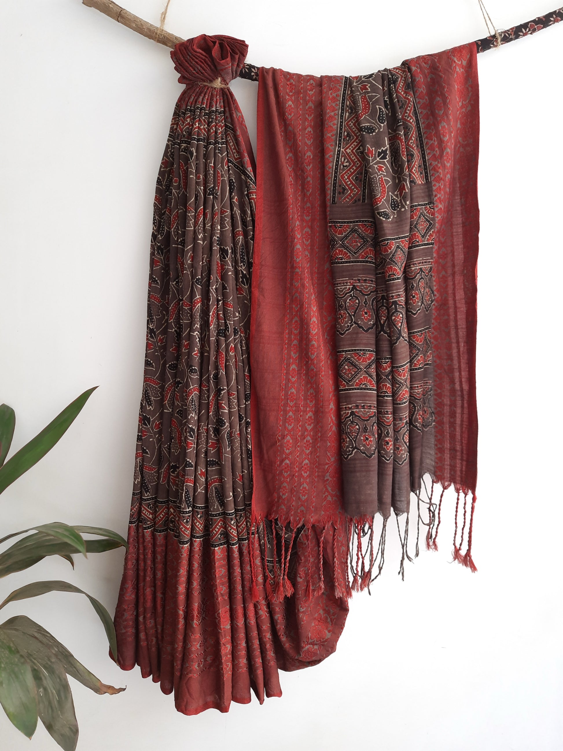 Brown and madder Ajrakh hand block printed cotton saree featuring a brown printed body with madder red borders, self-woven detailing and tassels made from the saree’s own fabric. Natural dyed, breathable, slow made saree handcrafted in Gujarat.