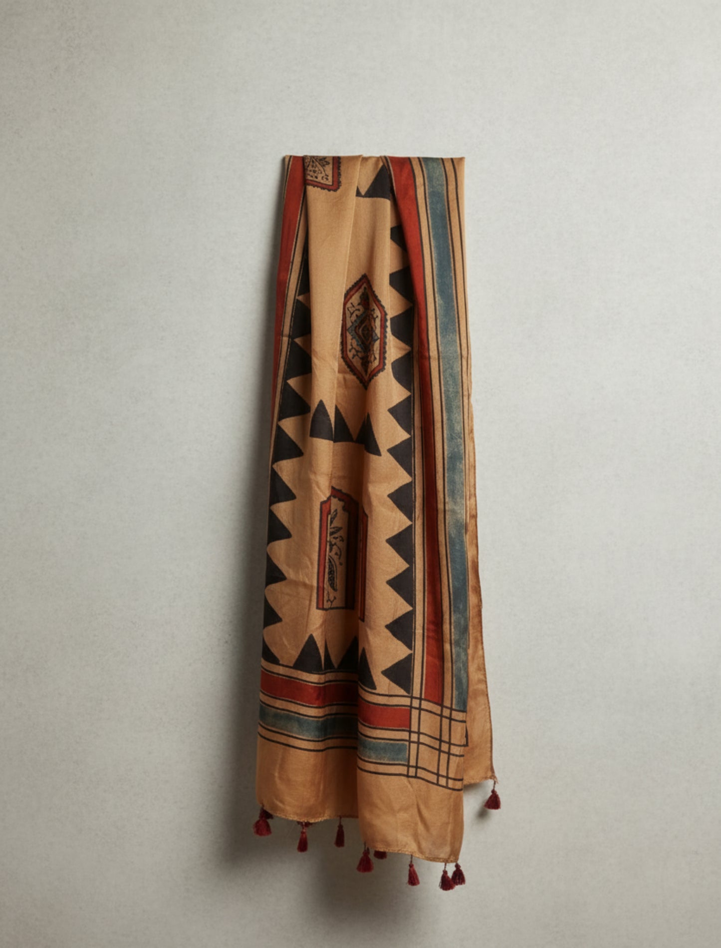 Earthy peach Ajrakh modal silk stole handcrafted with multiple hand block prints, naturally dyed with seasonal flowers, featuring a soft drape and tassels on both ends. Artisanal, sustainable, and one-of-a-kind.