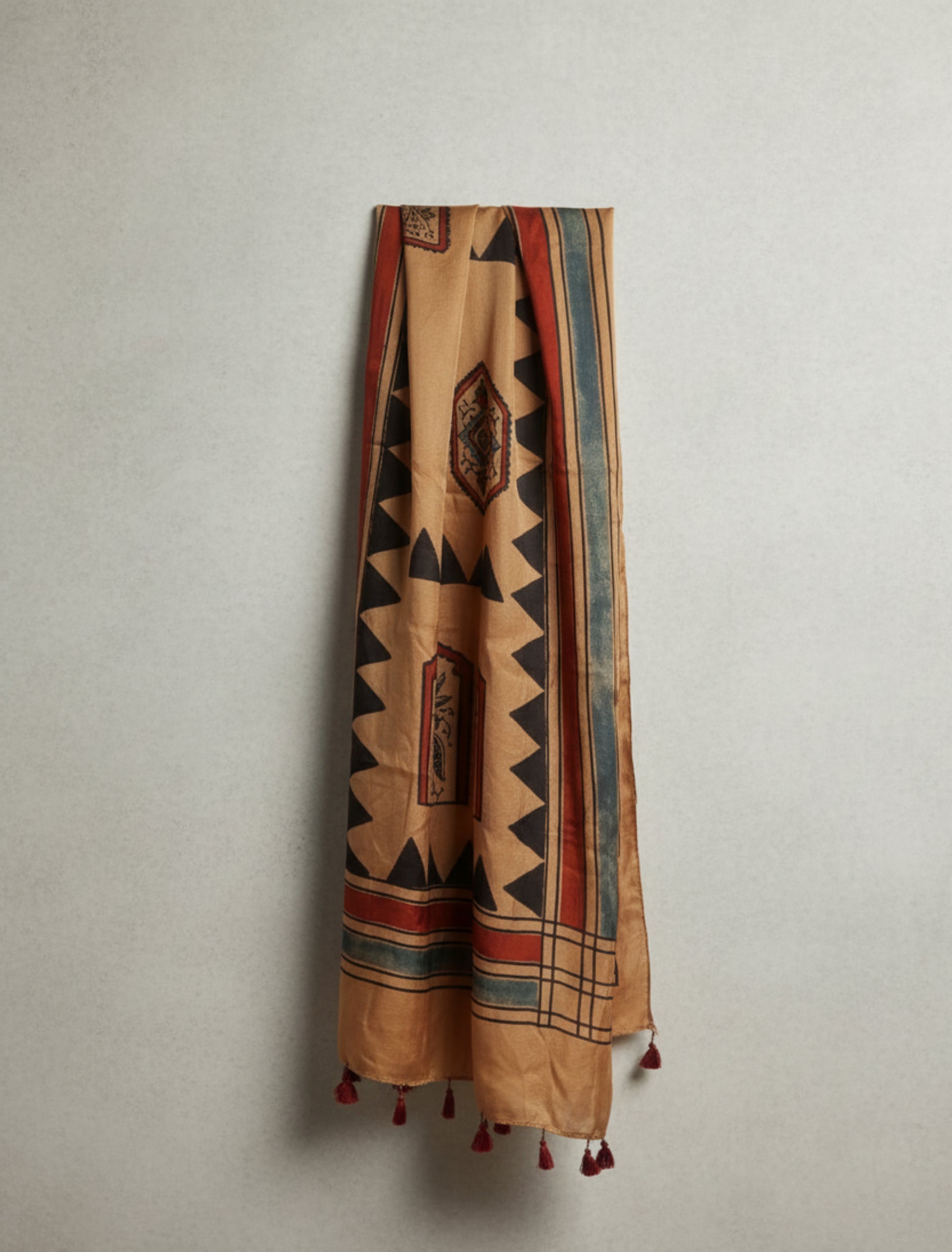 Earthy peach Ajrakh modal silk stole handcrafted with multiple hand block prints, naturally dyed with seasonal flowers, featuring a soft drape and tassels on both ends. Artisanal, sustainable, and one-of-a-kind.