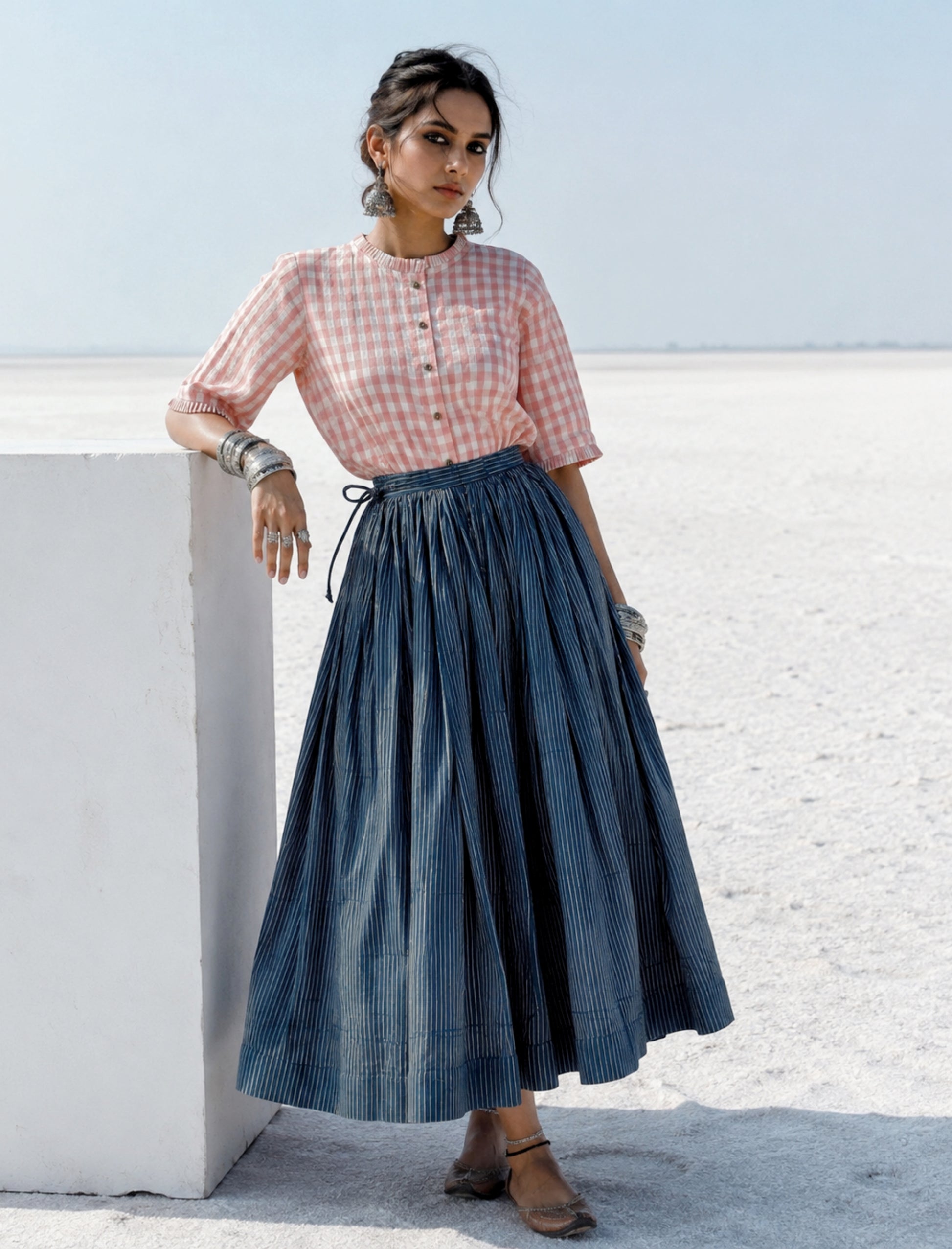 Cotton indigo dyed Ajrakh hand block printed stripes skirt with gathered waistband, adjustable tie strings and concealed side zip in a flowing ankle-length silhouette.
